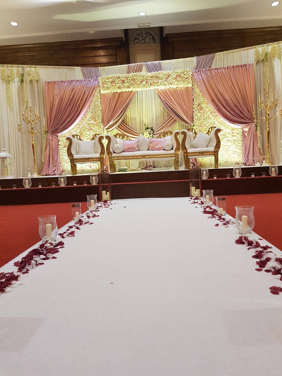 a white table with rose petals on it.