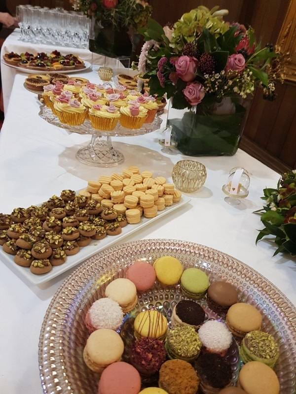 a table topped with lots of different types of desserts.