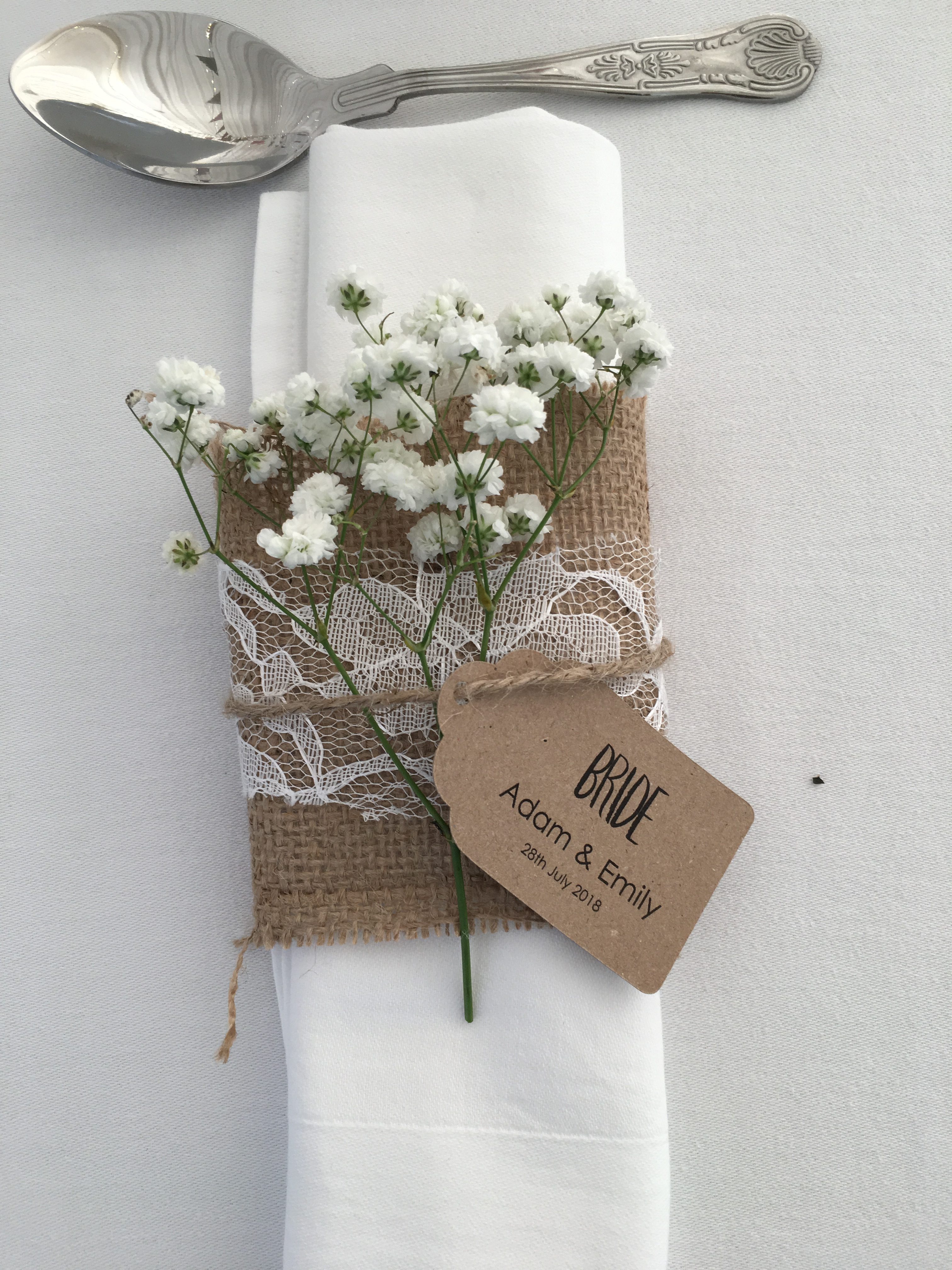 a napkin with a tag on it and a bunch of flowers on it.