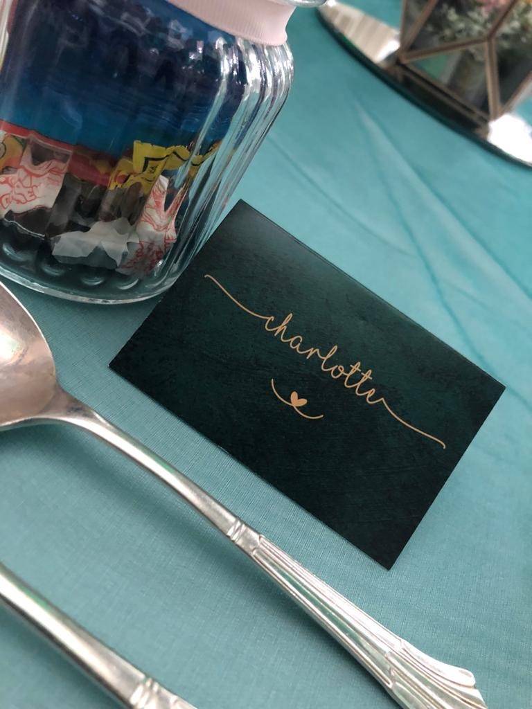 a place setting with a place card and a spoon.
