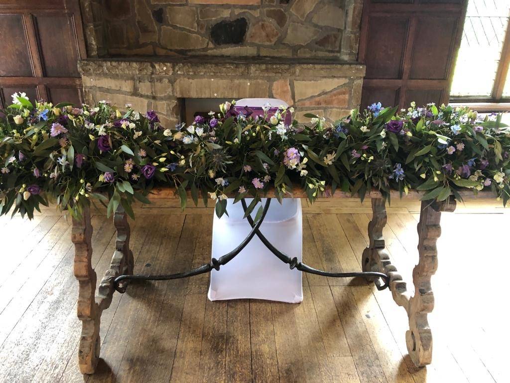 a table with a bunch of flowers on top of it.
