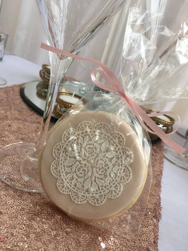 a decorated cookie in a vase on a table.