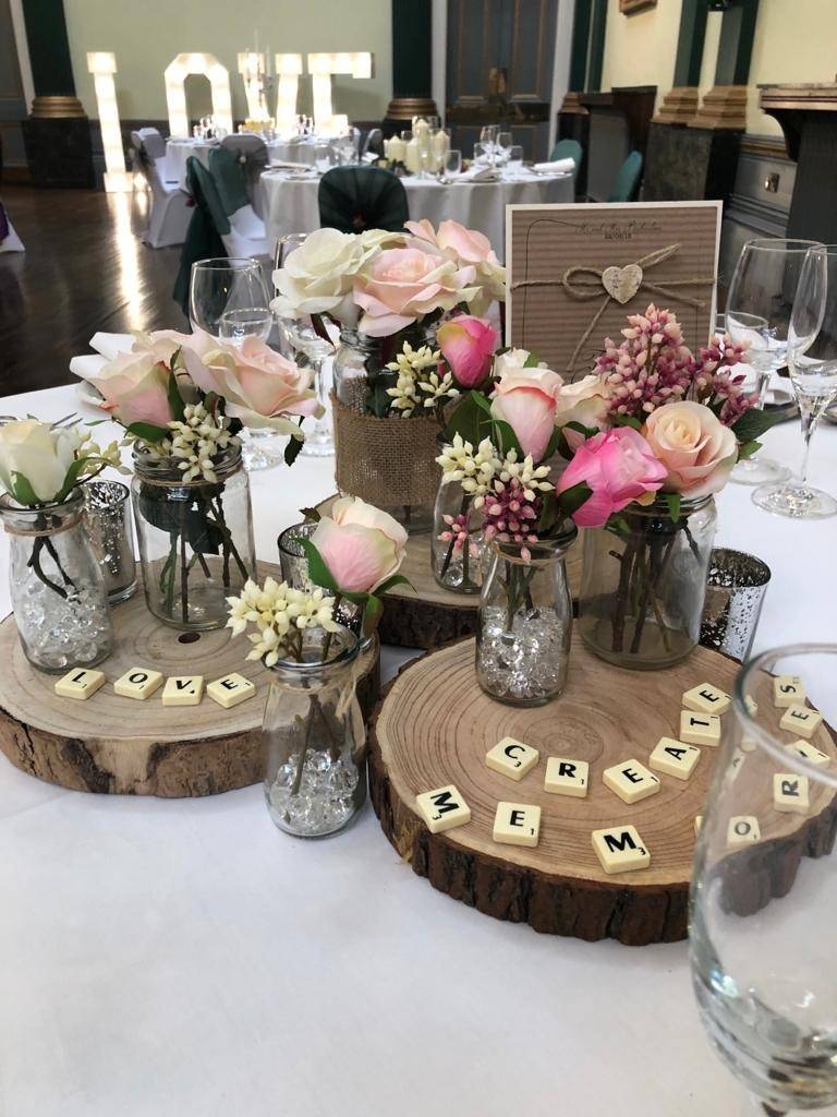 a table topped with vases filled with flowers.