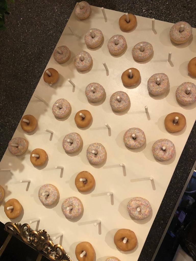 a display of doughnuts on a white board.