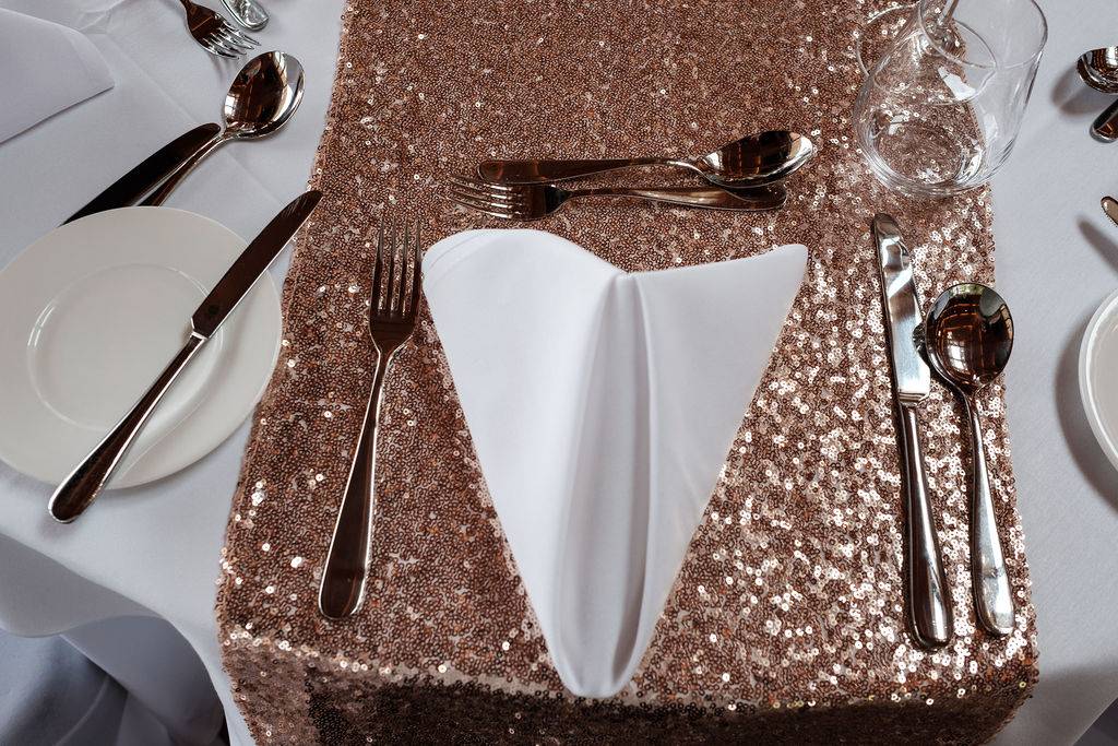 a table set with a napkin, silverware and silverware.