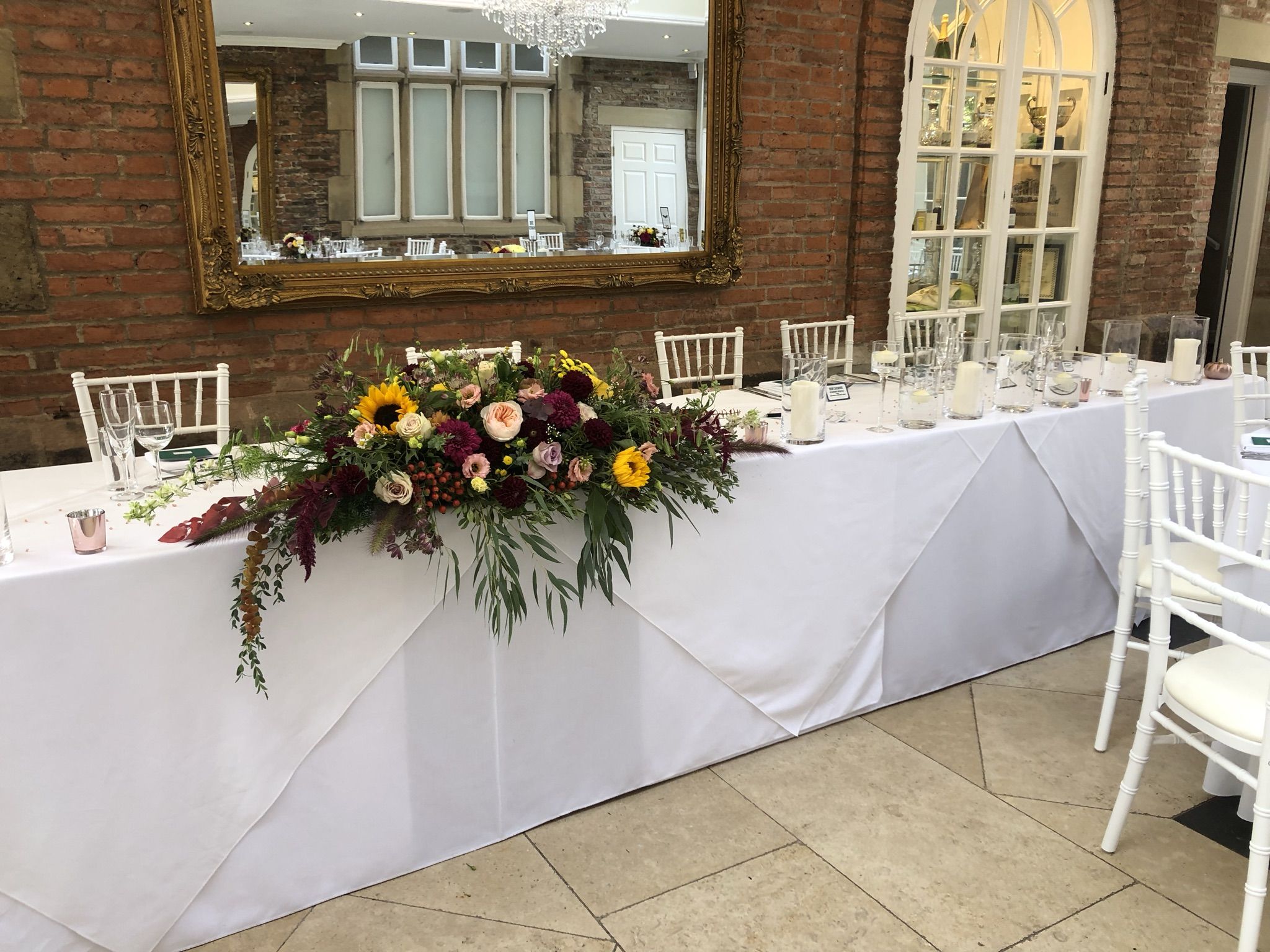 a table with flowers and candles on it.