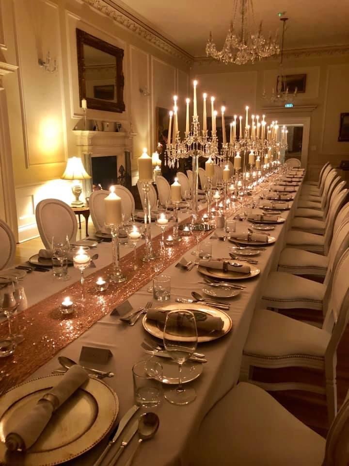 a long table is set for a formal dinner.