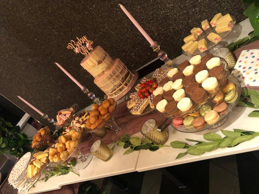 a table topped with lots of cakes and desserts.