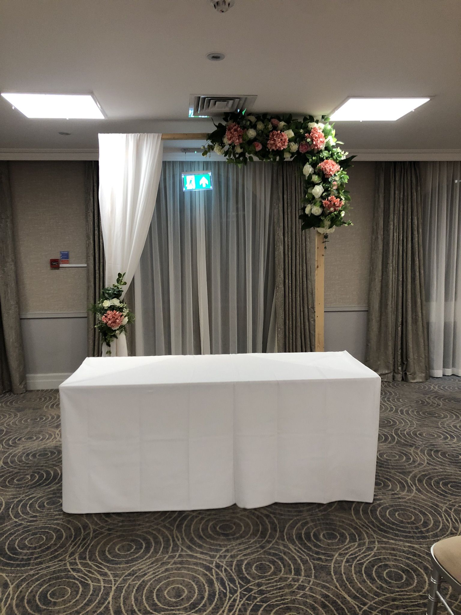 a table with a white table cloth and flowers on it.