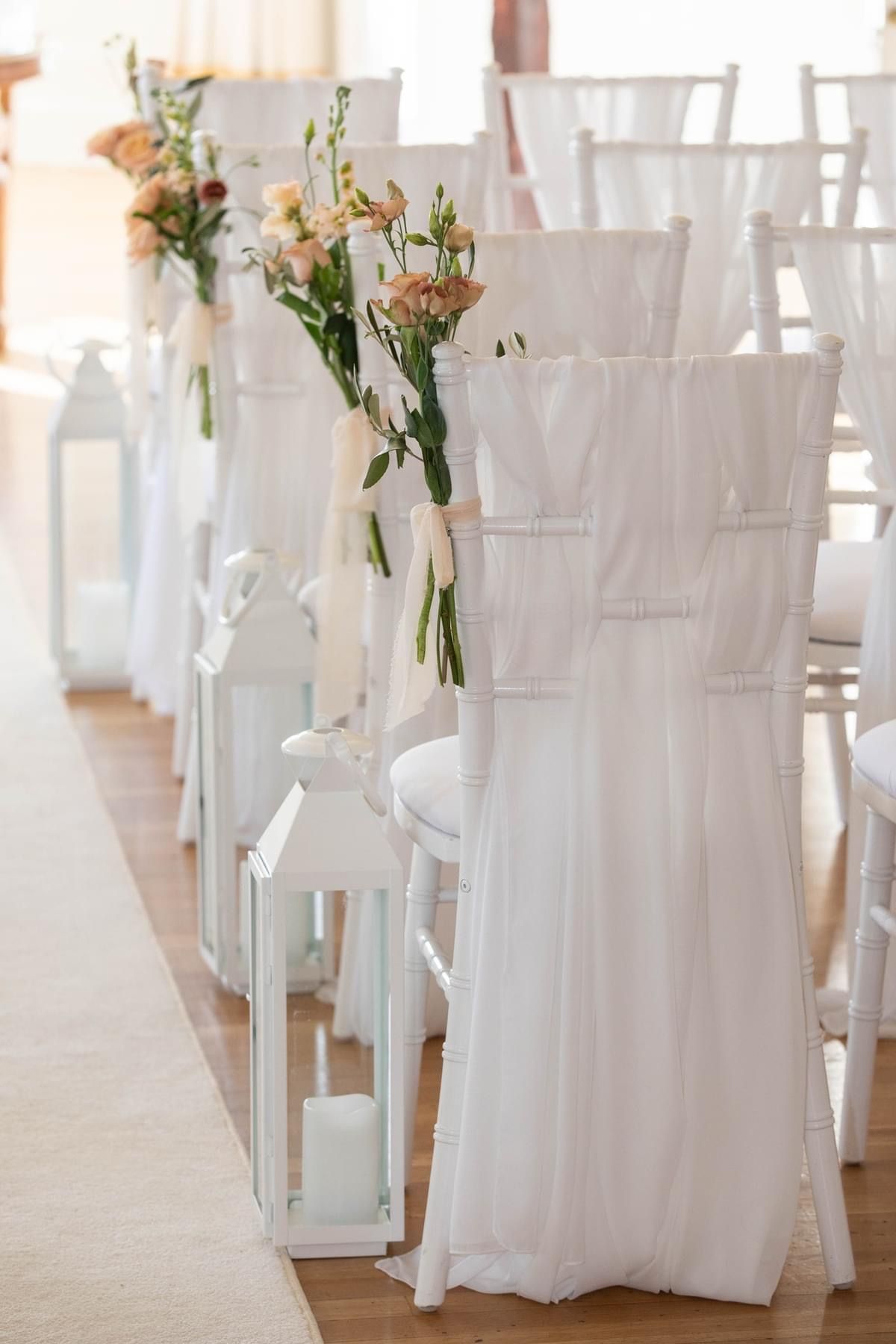 a row of white chairs sitting next to each other.