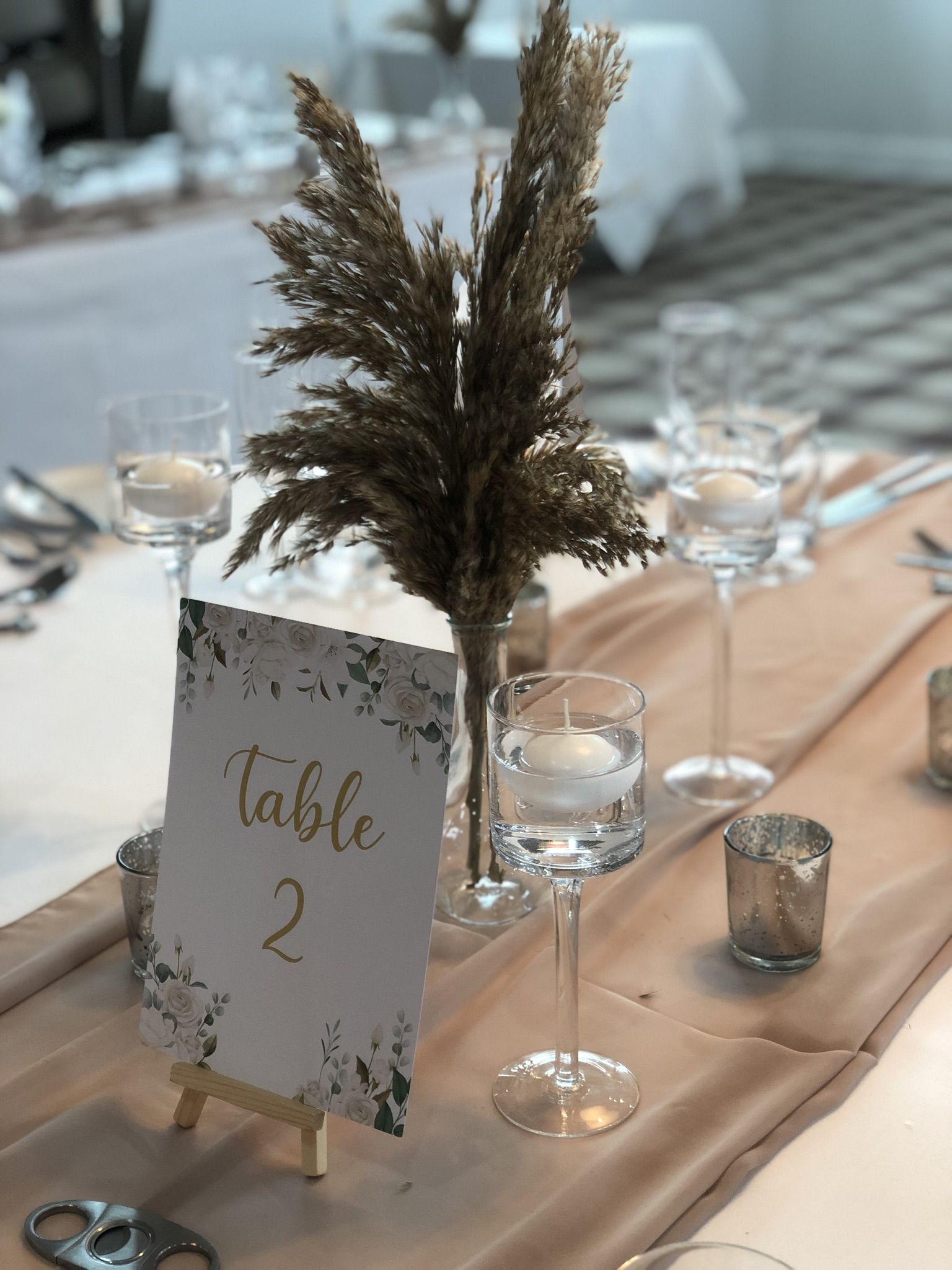 a table is set with a place card and wine glasses.