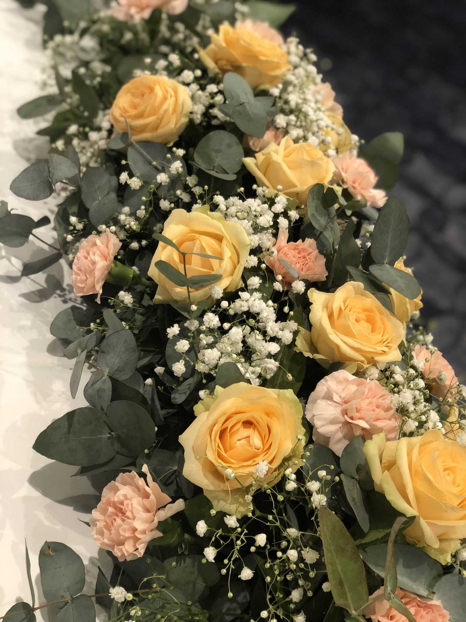 a bouquet of yellow roses and baby's breath.