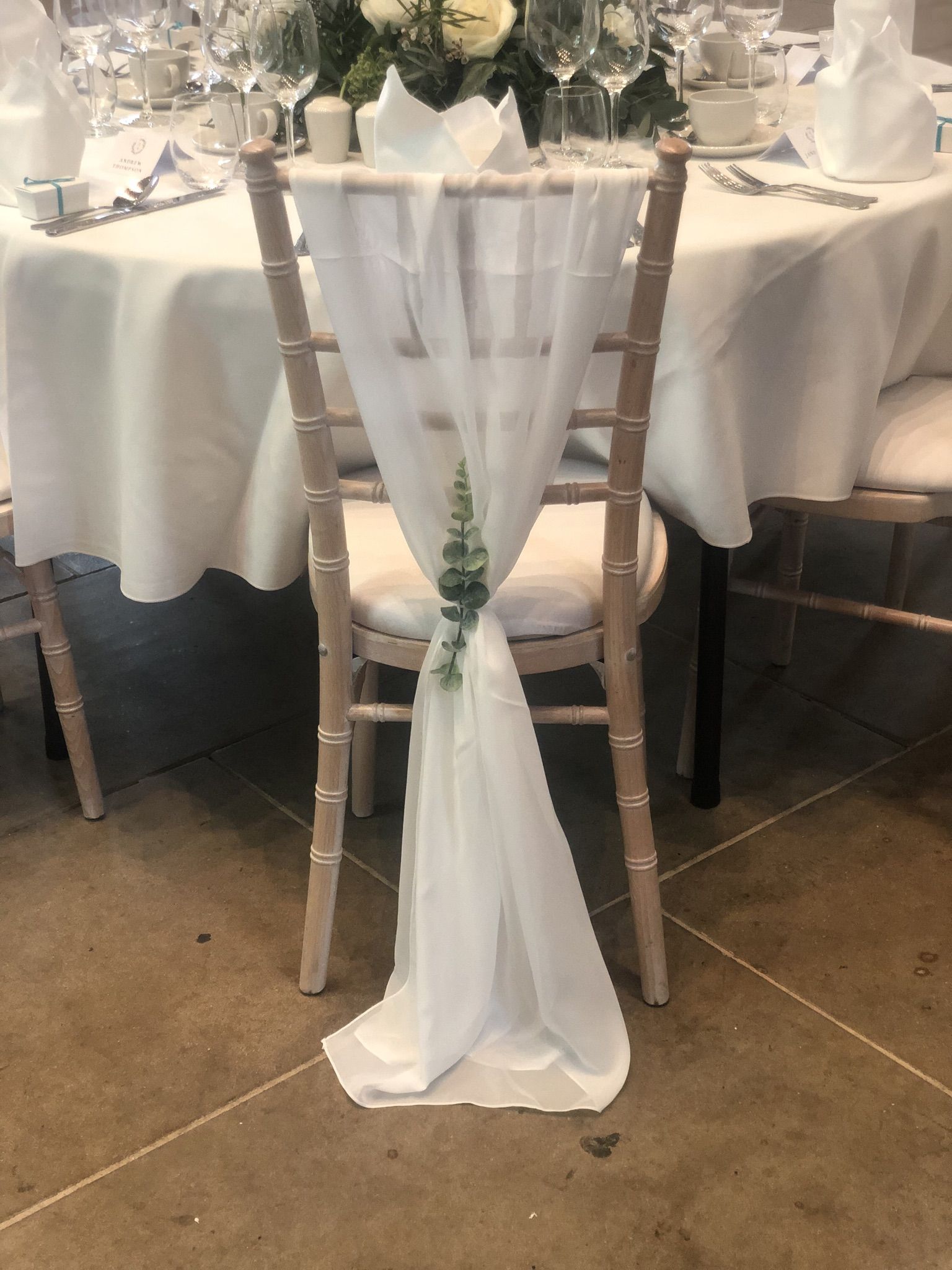 a table with a white cloth draped over it.