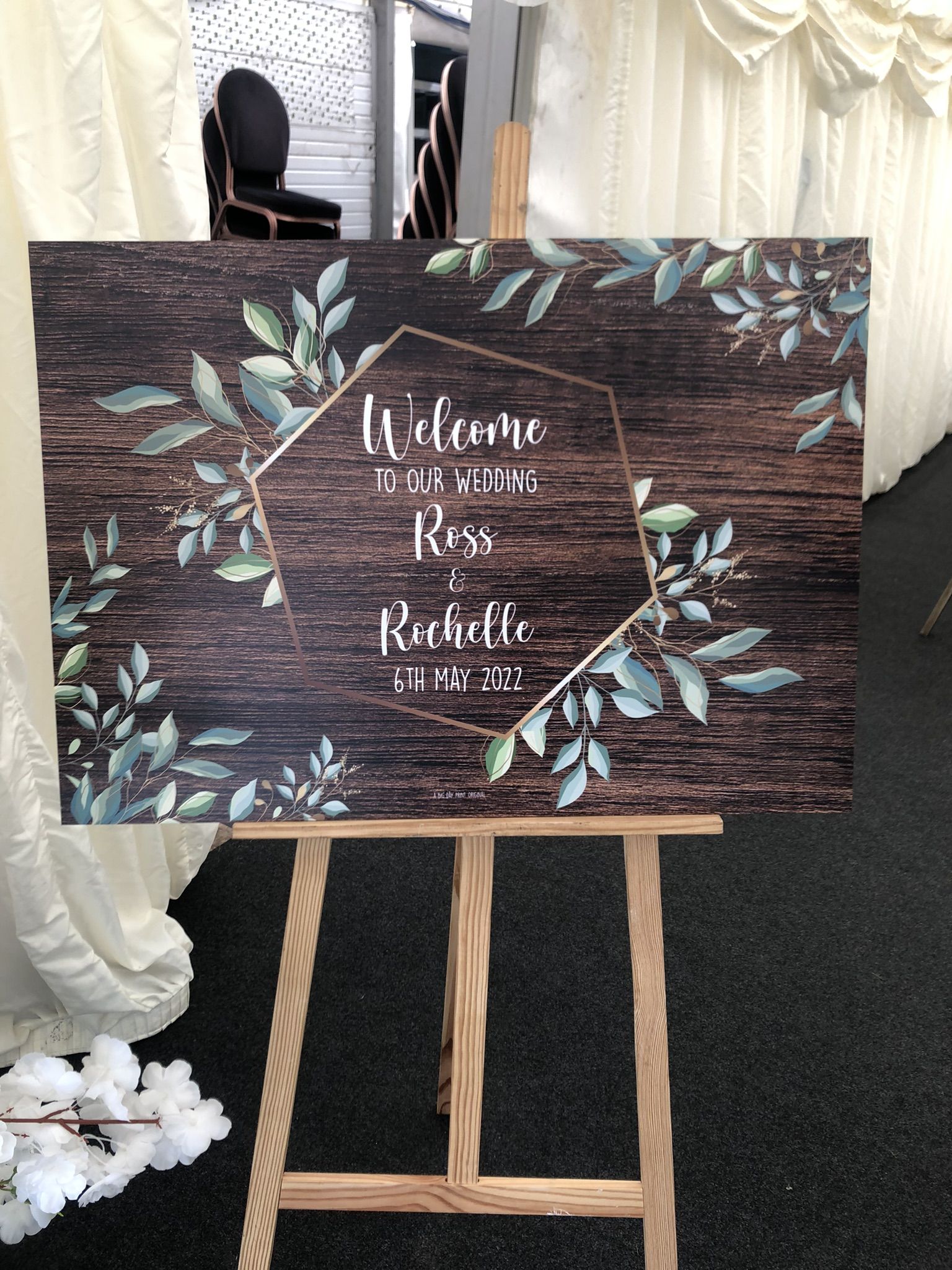 a welcome to our wedding sign on a easel.