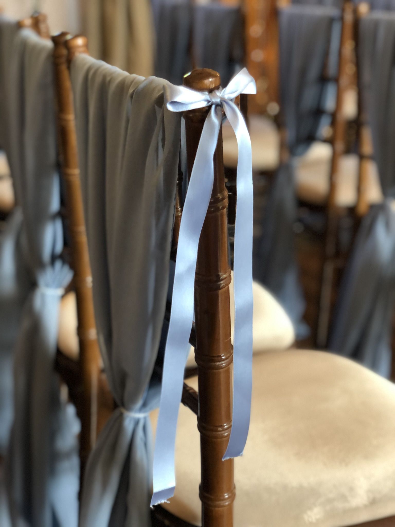 a close up of a chair with a ribbon on it.