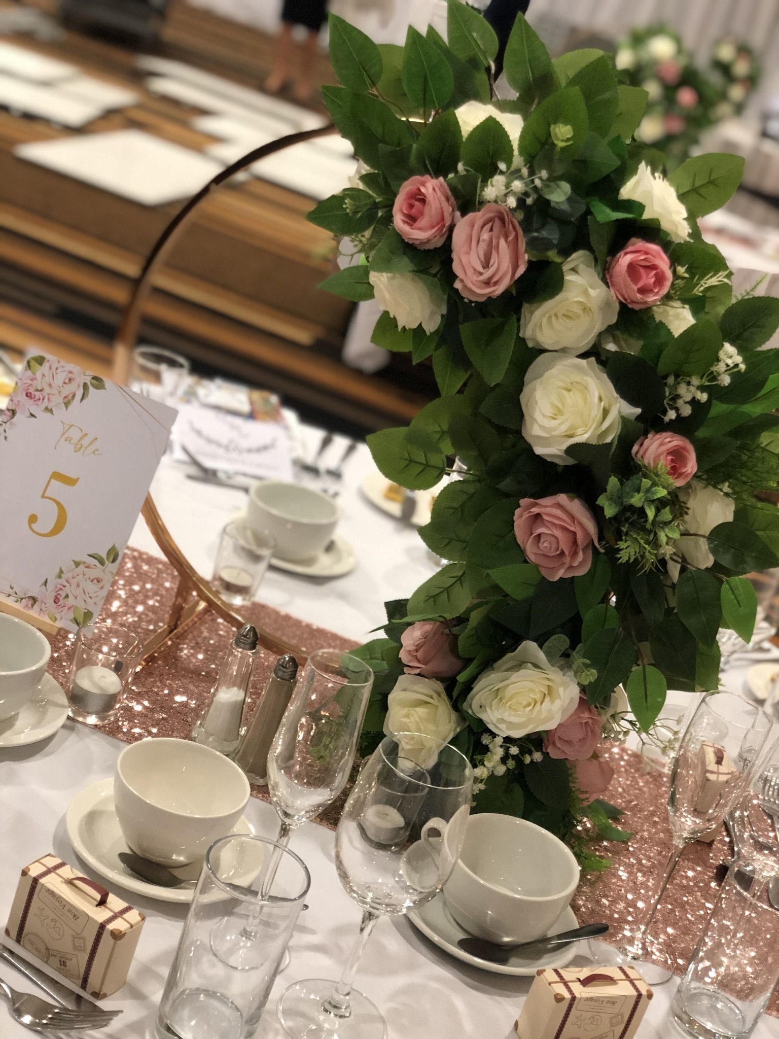 a table topped with lots of white and pink flowers.