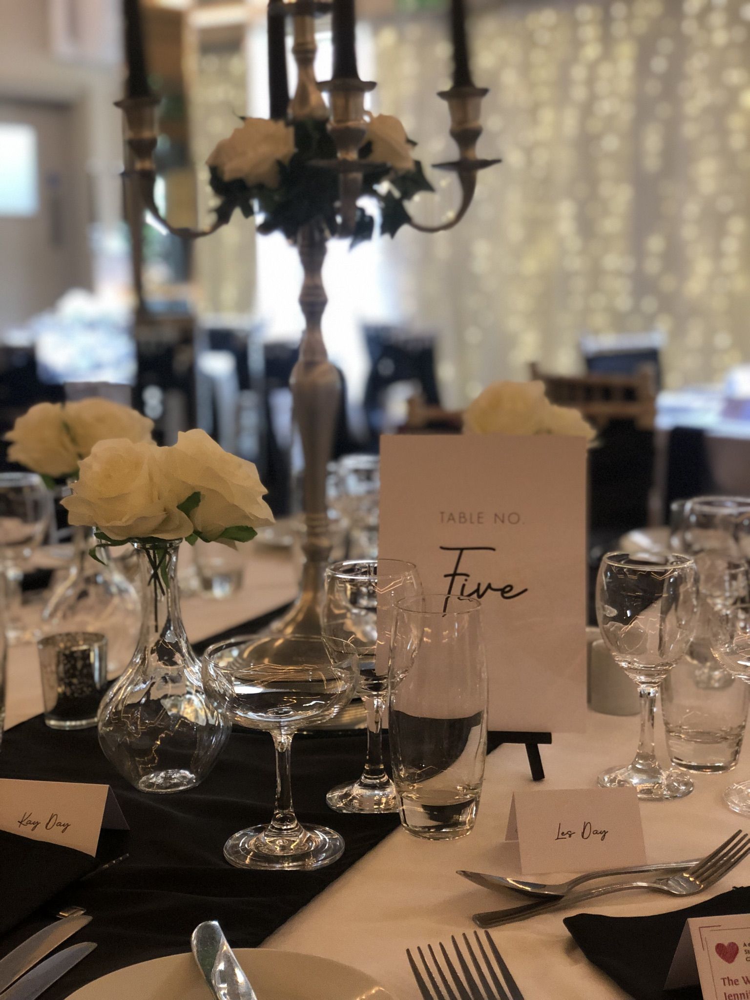 a table set with place cards and wine glasses.