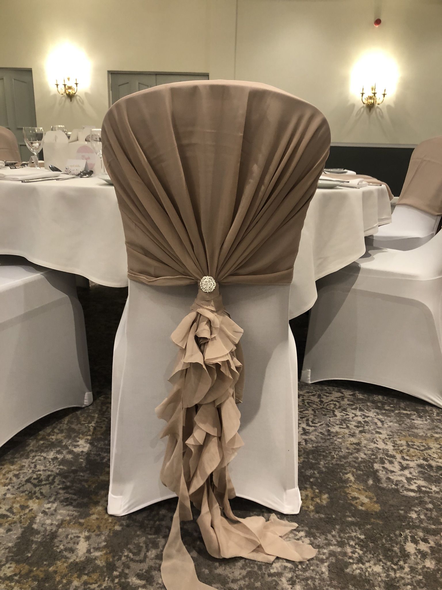 a chair with a ruffled sash on top of it.