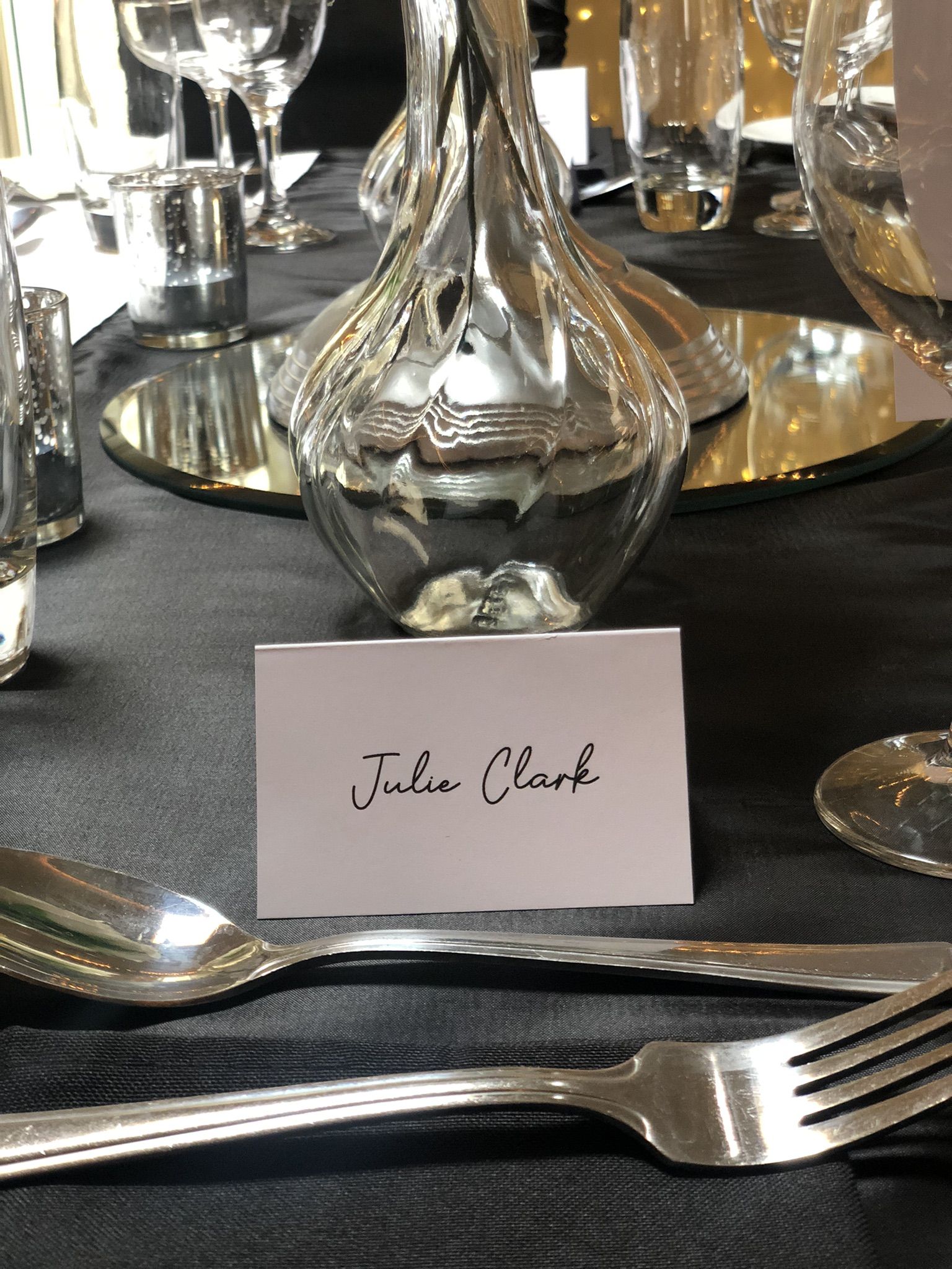 a table with a place card and silverware.