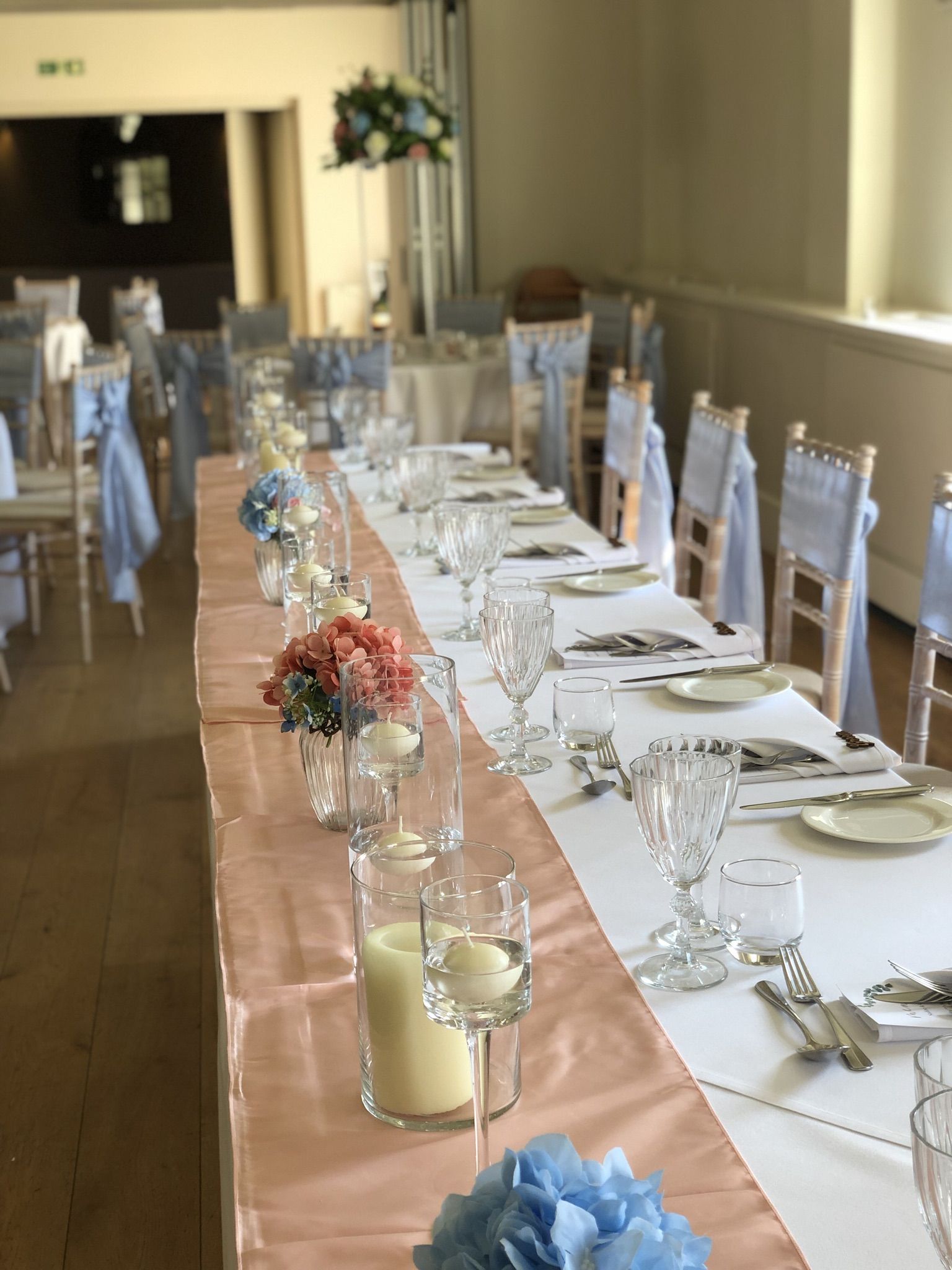 a long table is set for a formal function.