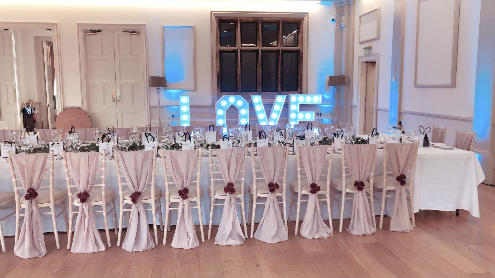 a long table with chairs and a sign that says love.