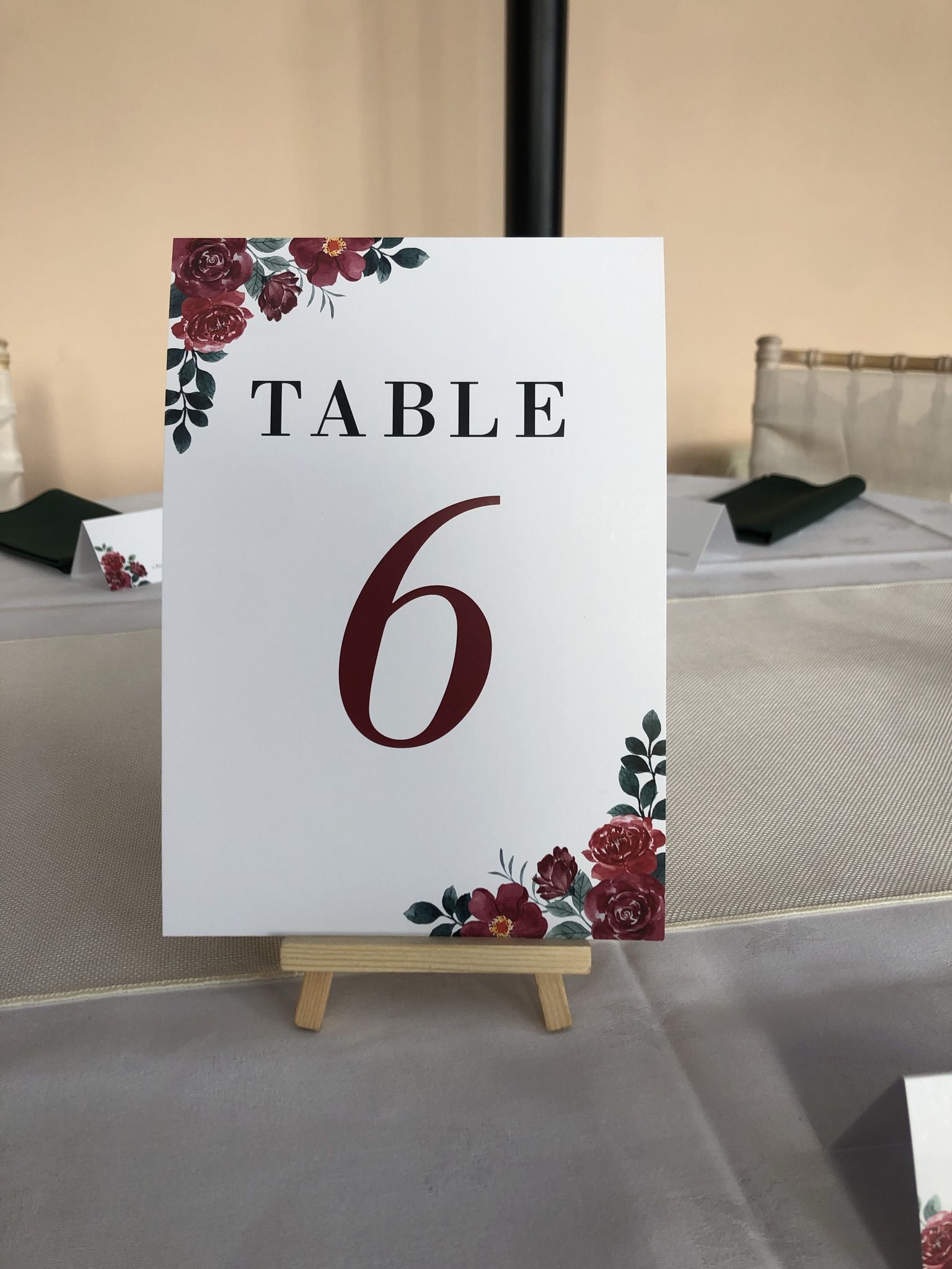 a table number is displayed on a wooden easel.