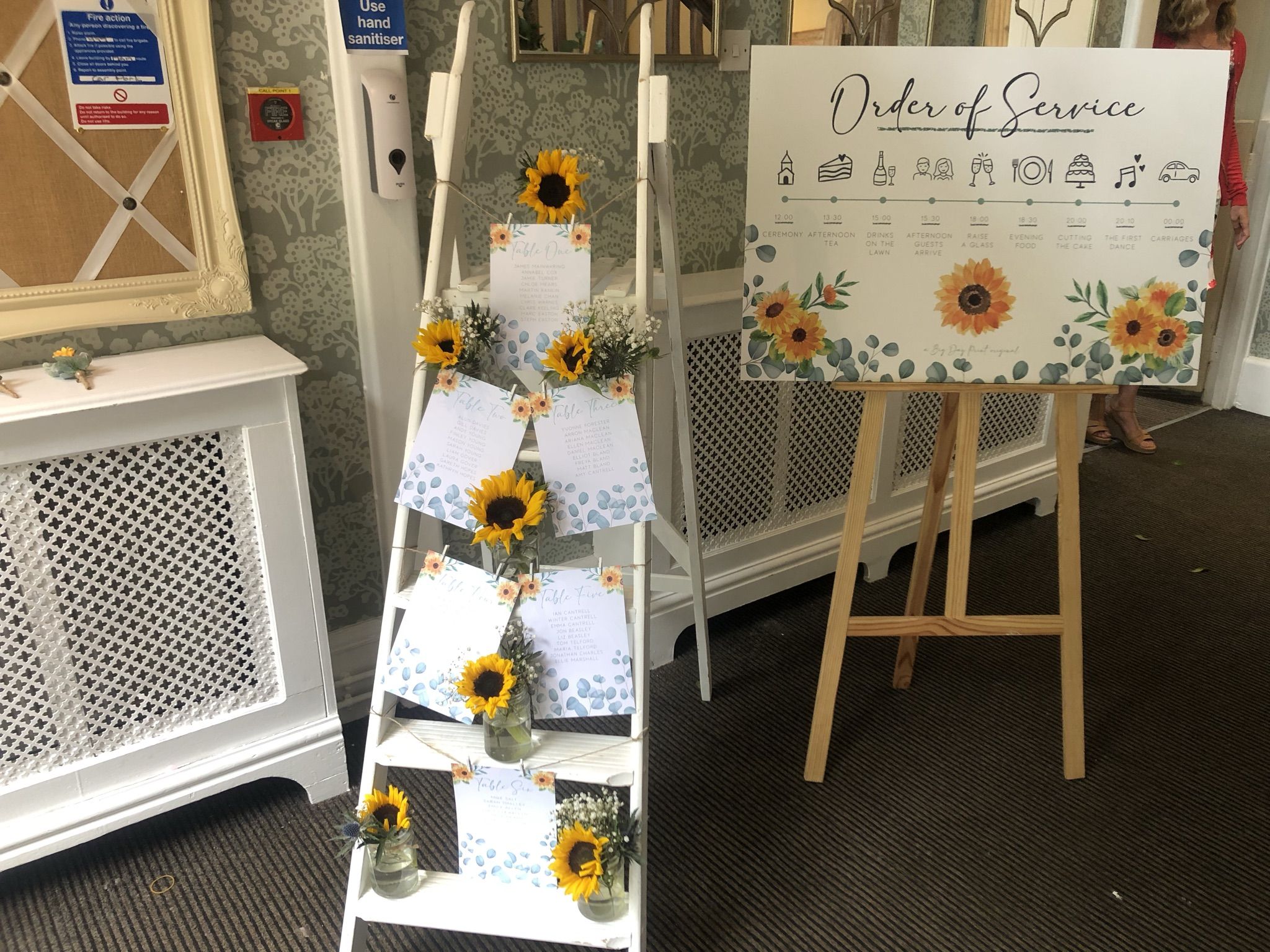 a display of cards and sunflowers in a room.
