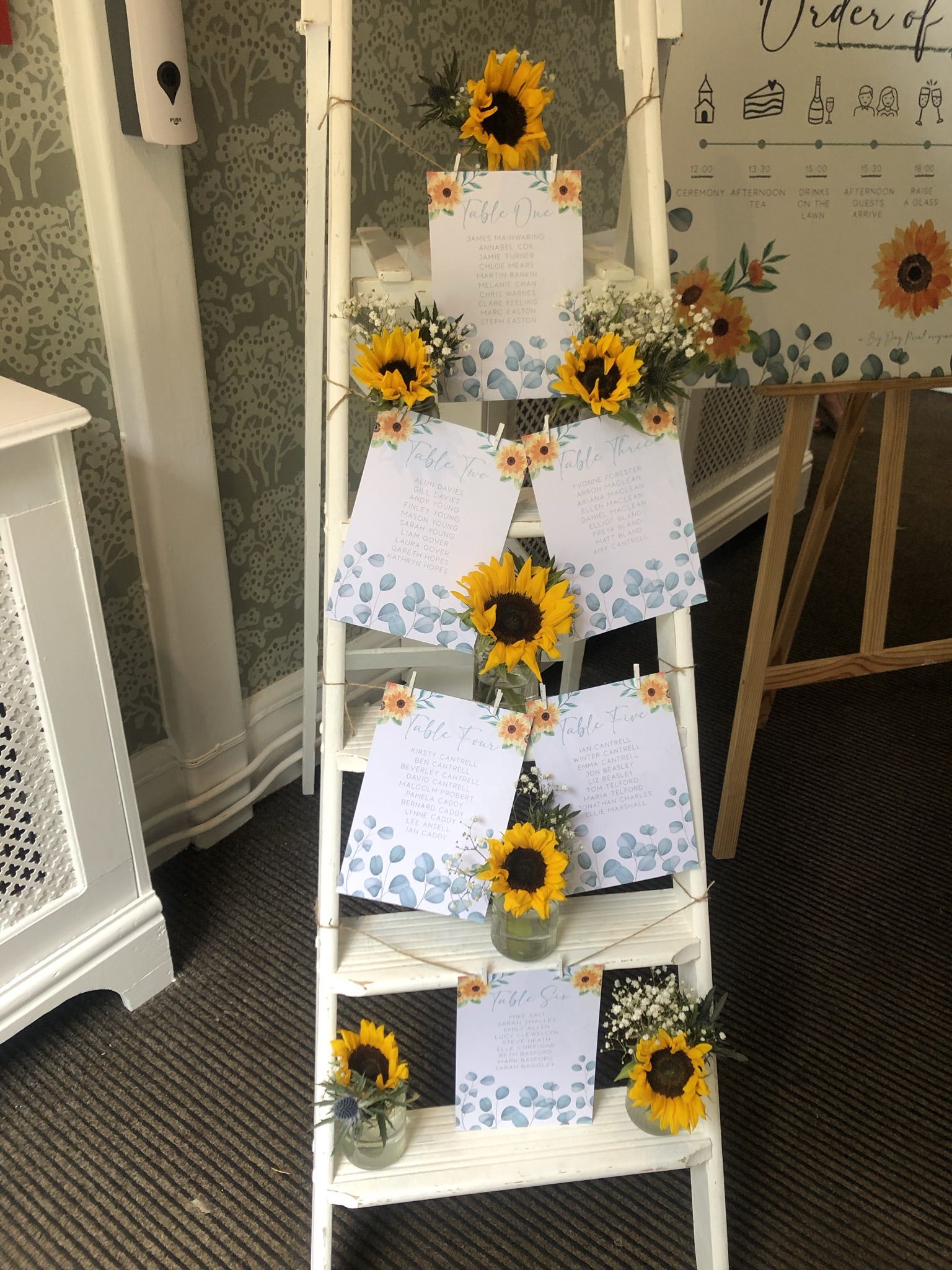 a ladder decorated with sunflowers and notes.