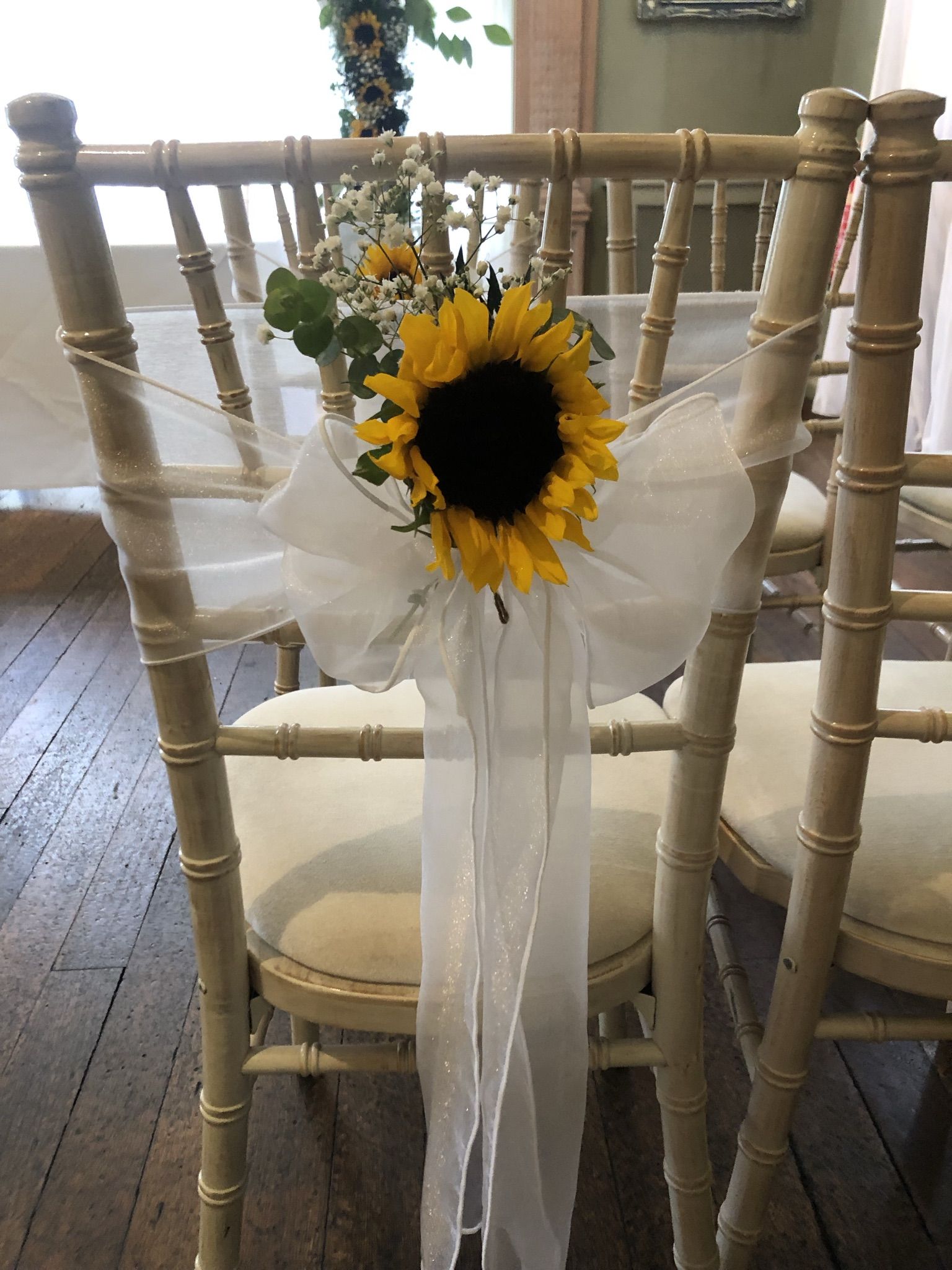 a bouquet of sunflowers tied to a chair.