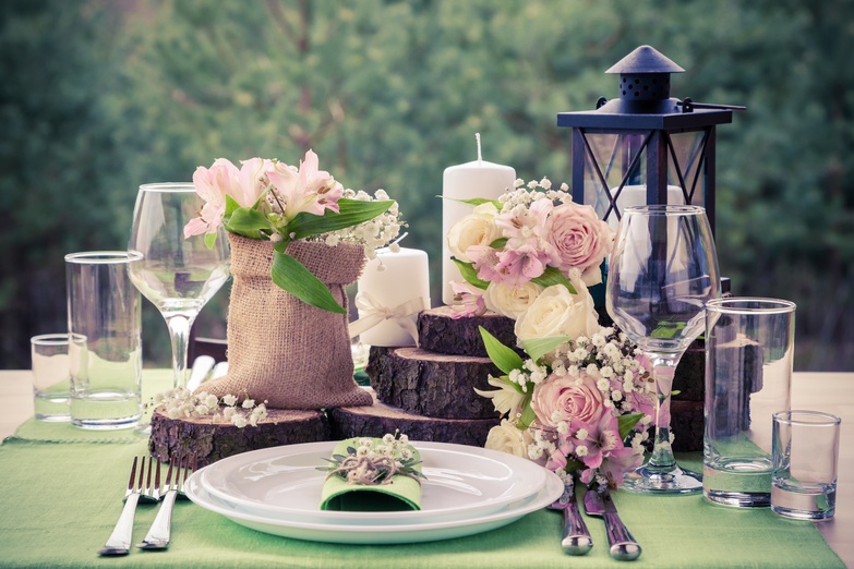 a table setting with flowers and candles.