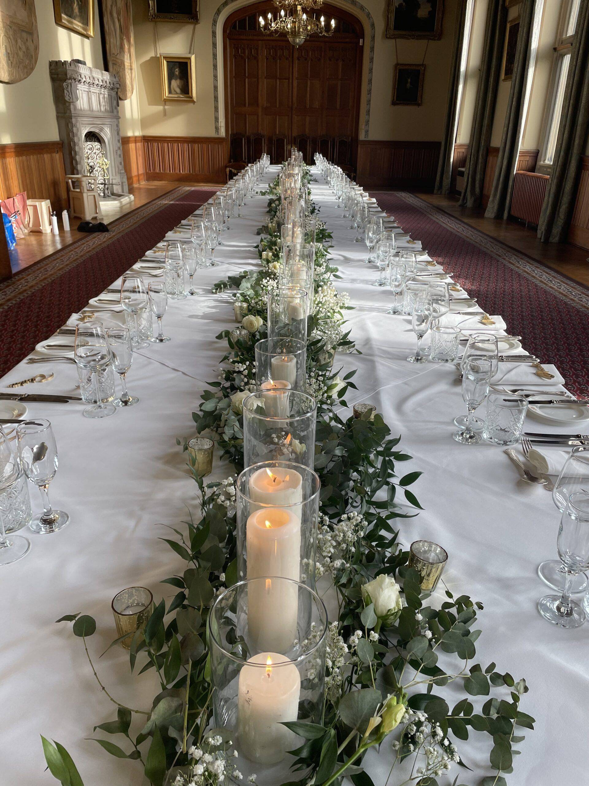 a long table with candles and flowers on it.