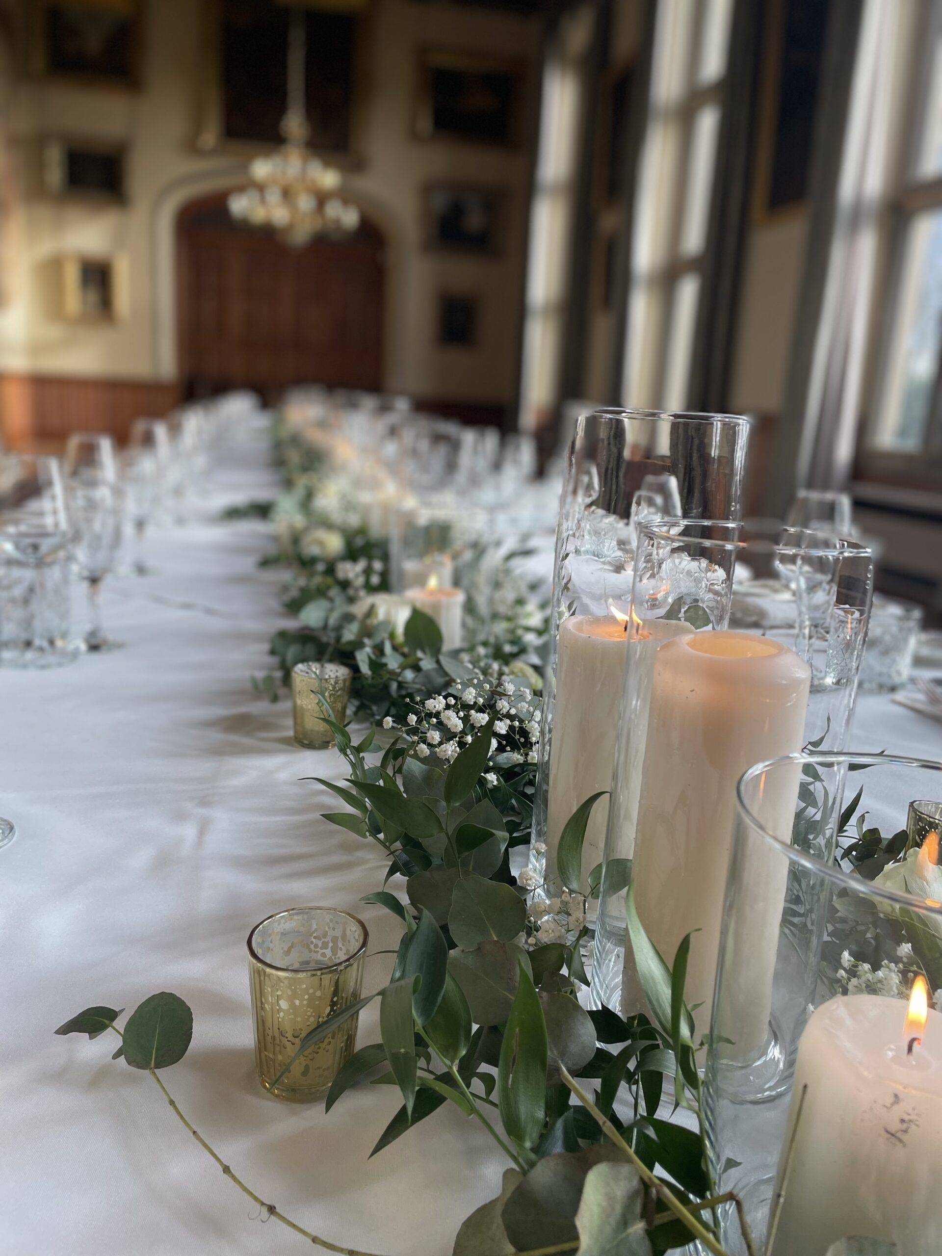 a long table with candles and flowers on it.