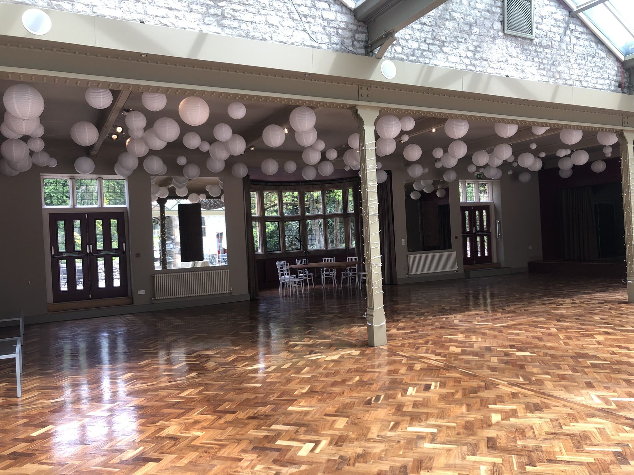 a large room with a lot of balloons hanging from the ceiling.