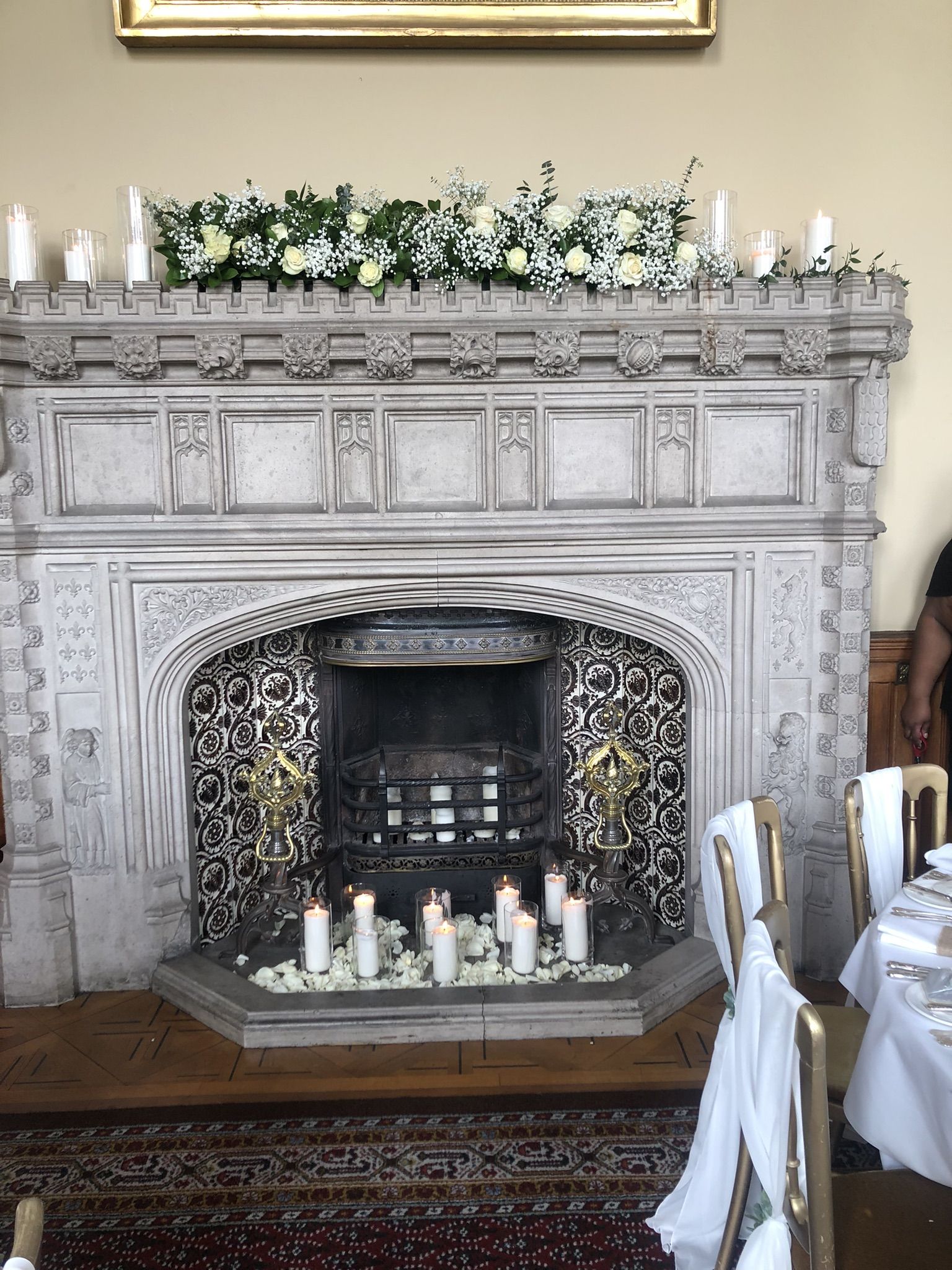 a fireplace with a bunch of candles on top of it.