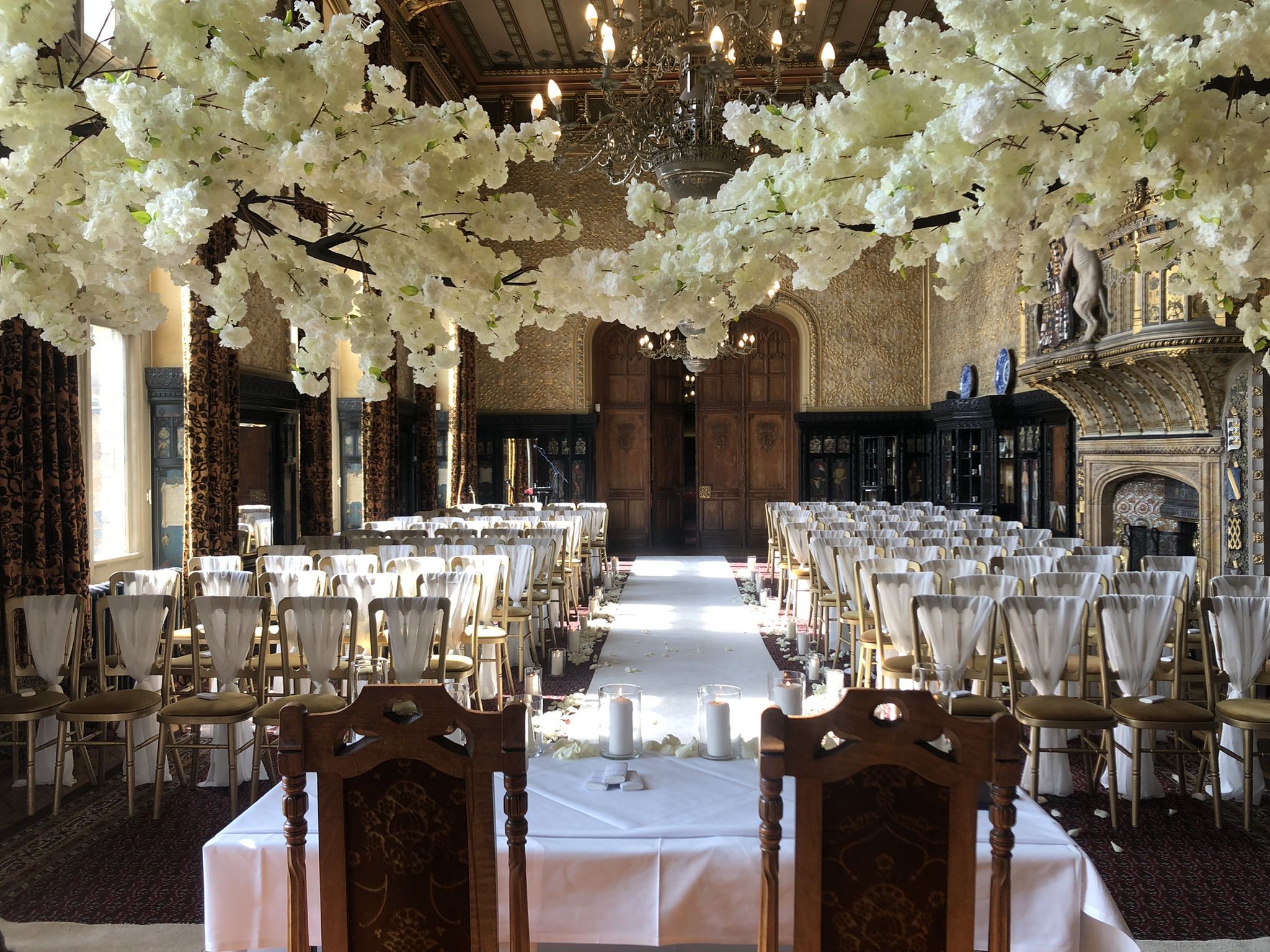 a room filled with tables and chairs covered in white flowers.
