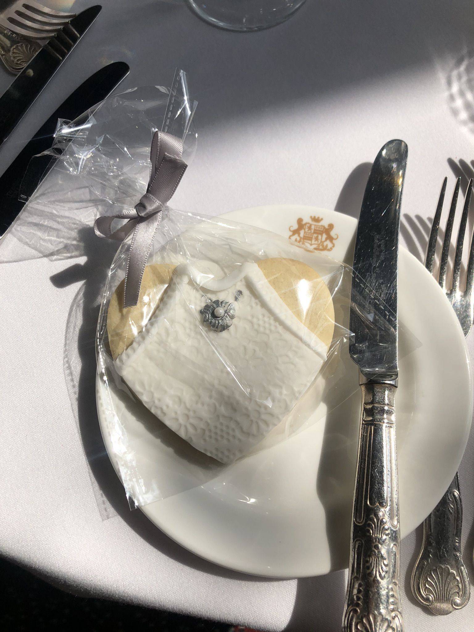 a white plate topped with a piece of cake next to a fork and knife.