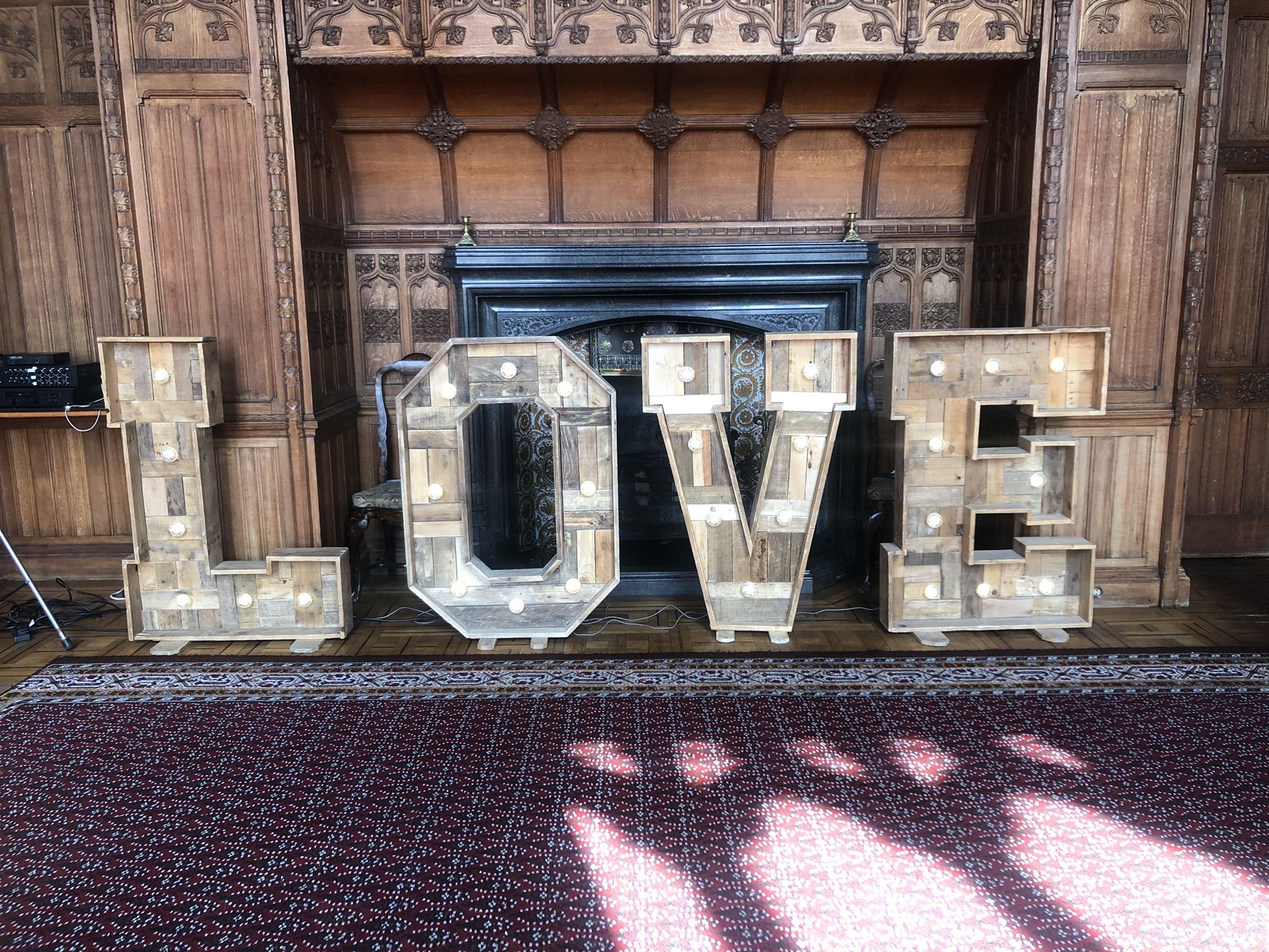 the word love spelled out in front of a fireplace.