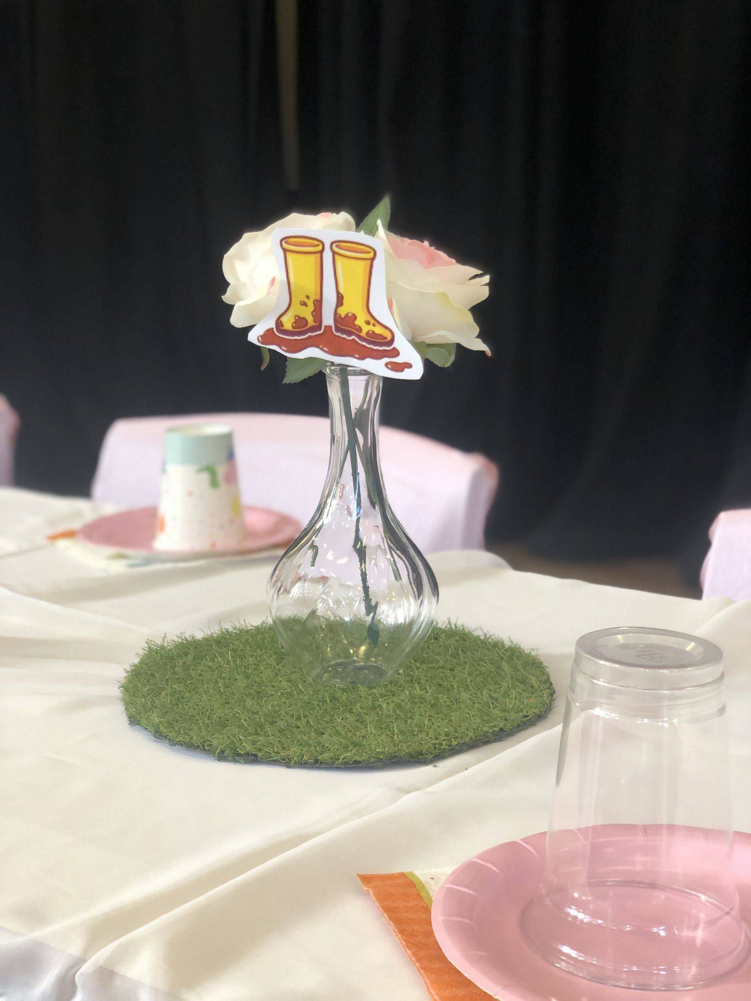 a vase with a flower in it on a table.