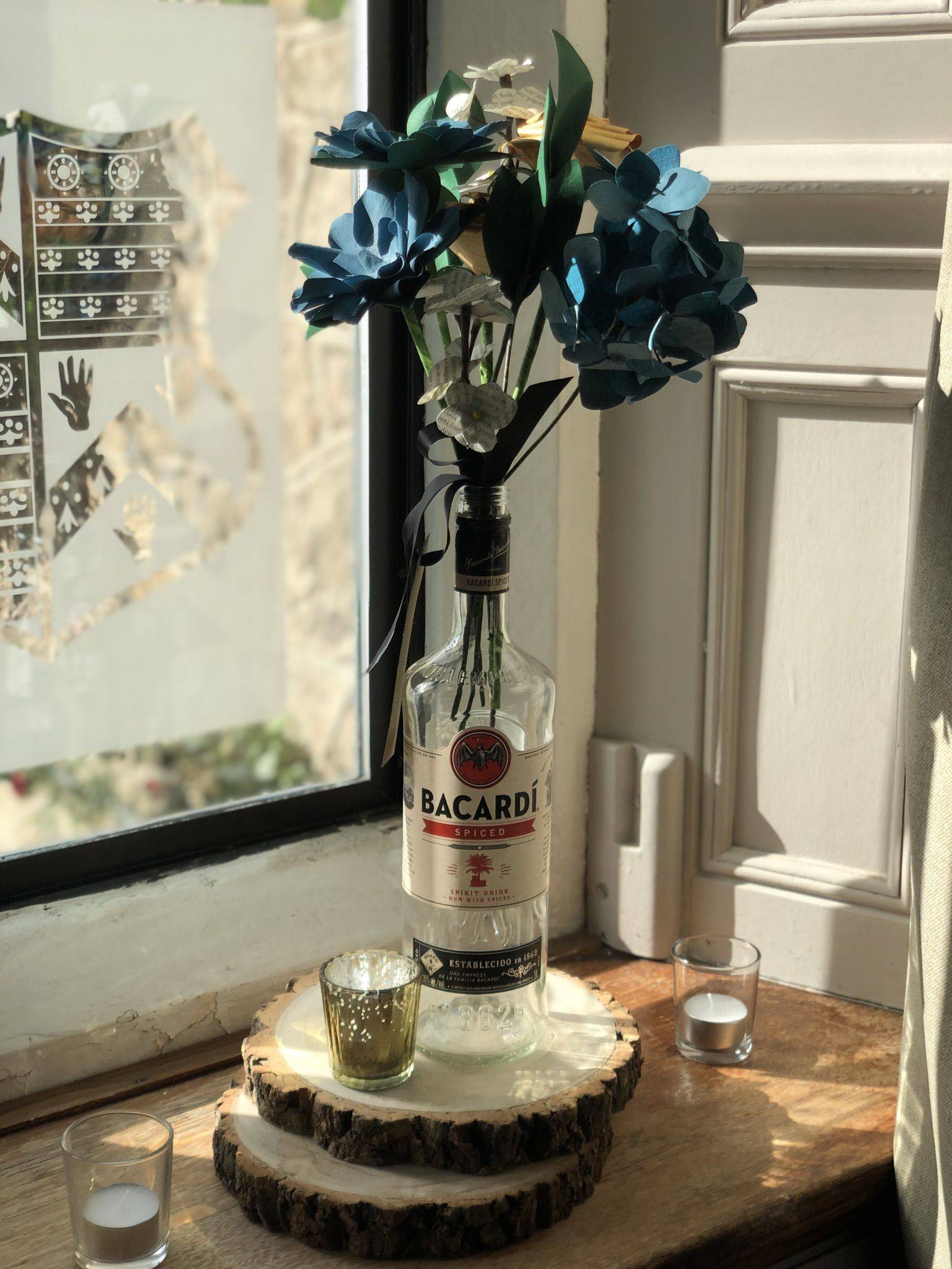 a bottle of liquor sitting on top of a wooden table.