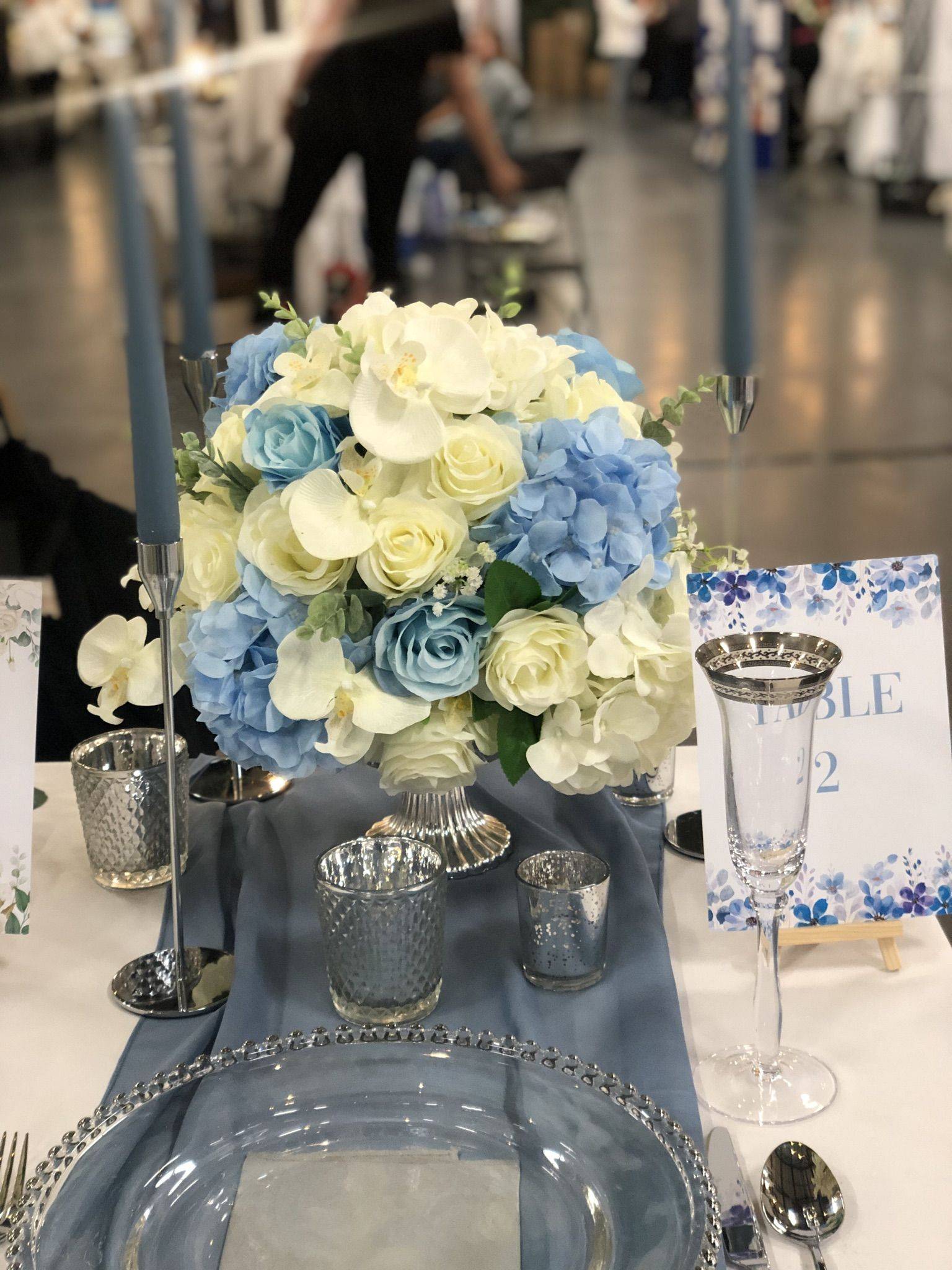 a blue and white centerpiece on a table.