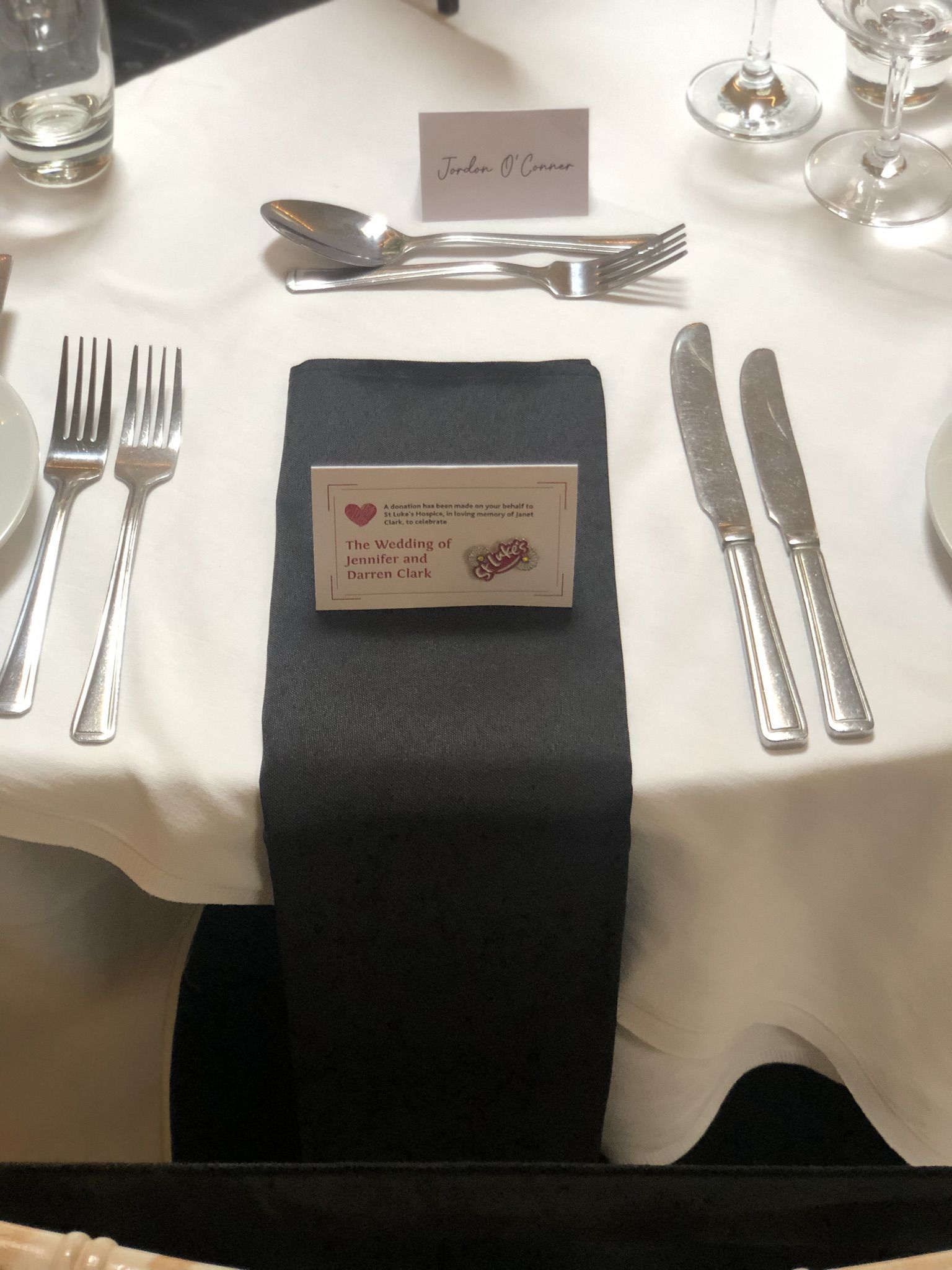 a table set with silverware and place cards.