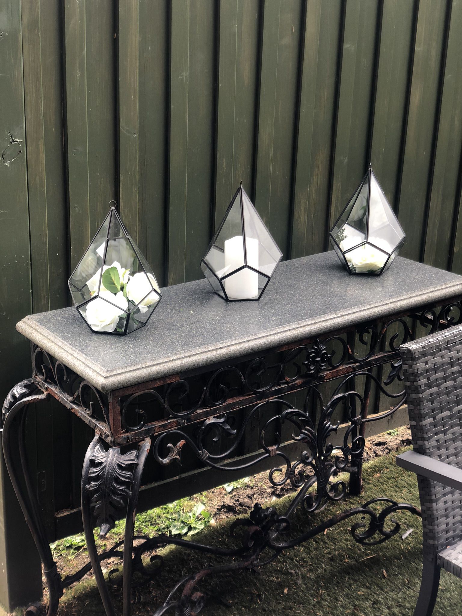 a table with three glass vases on top of it.