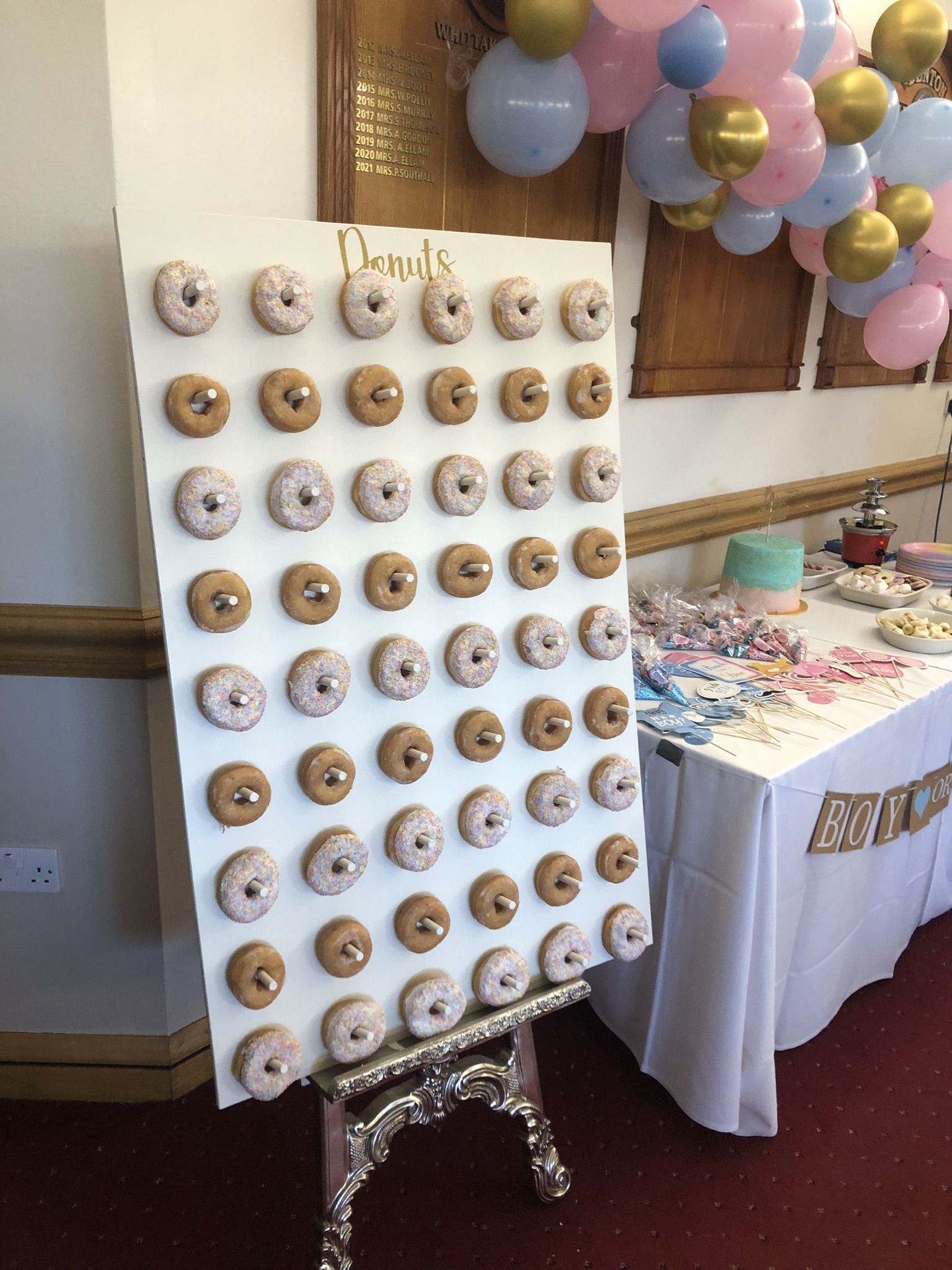 a display of doughnuts on a white board.