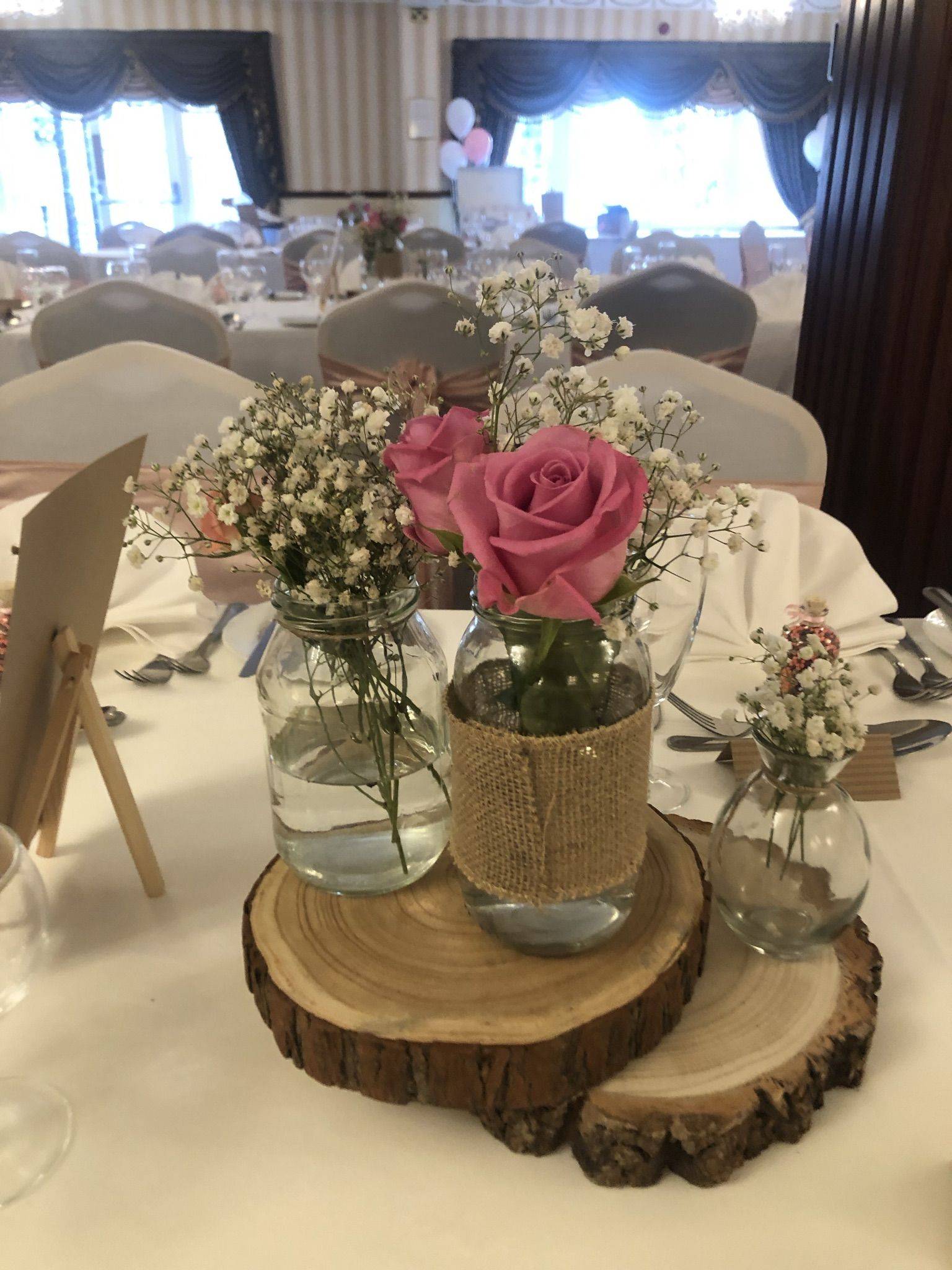 a table topped with vases filled with flowers.