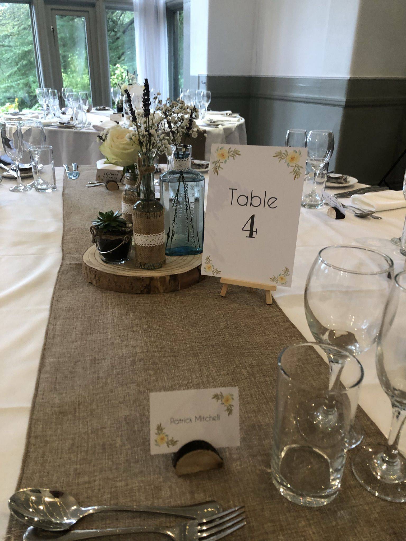 a table set up with place cards and silverware.