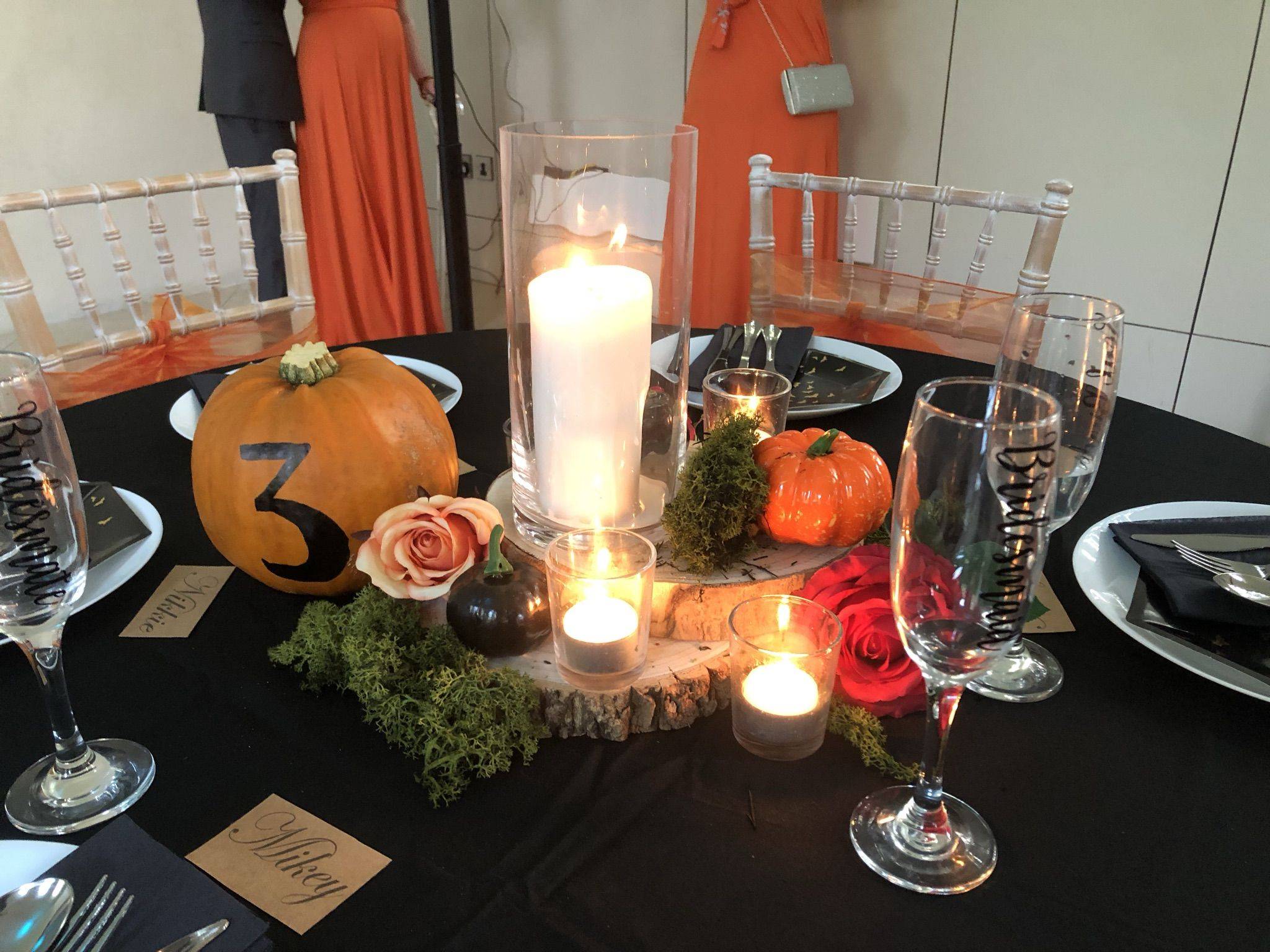a table topped with a candle surrounded by candles.