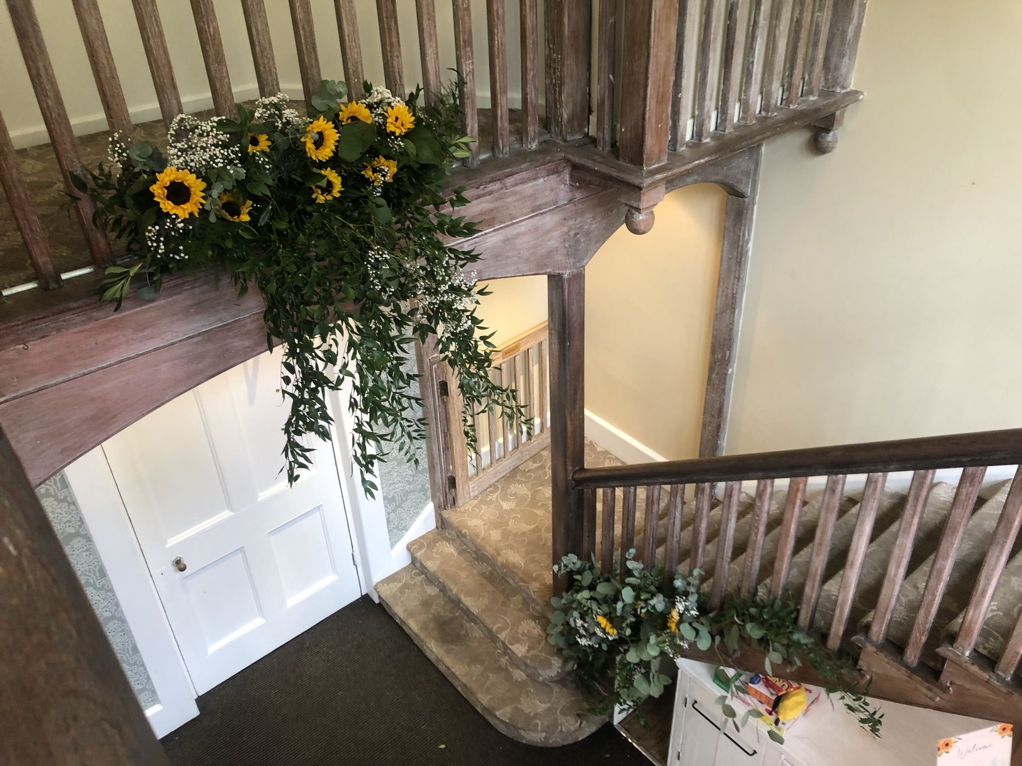 a bunch of sunflowers are hanging from a staircase.