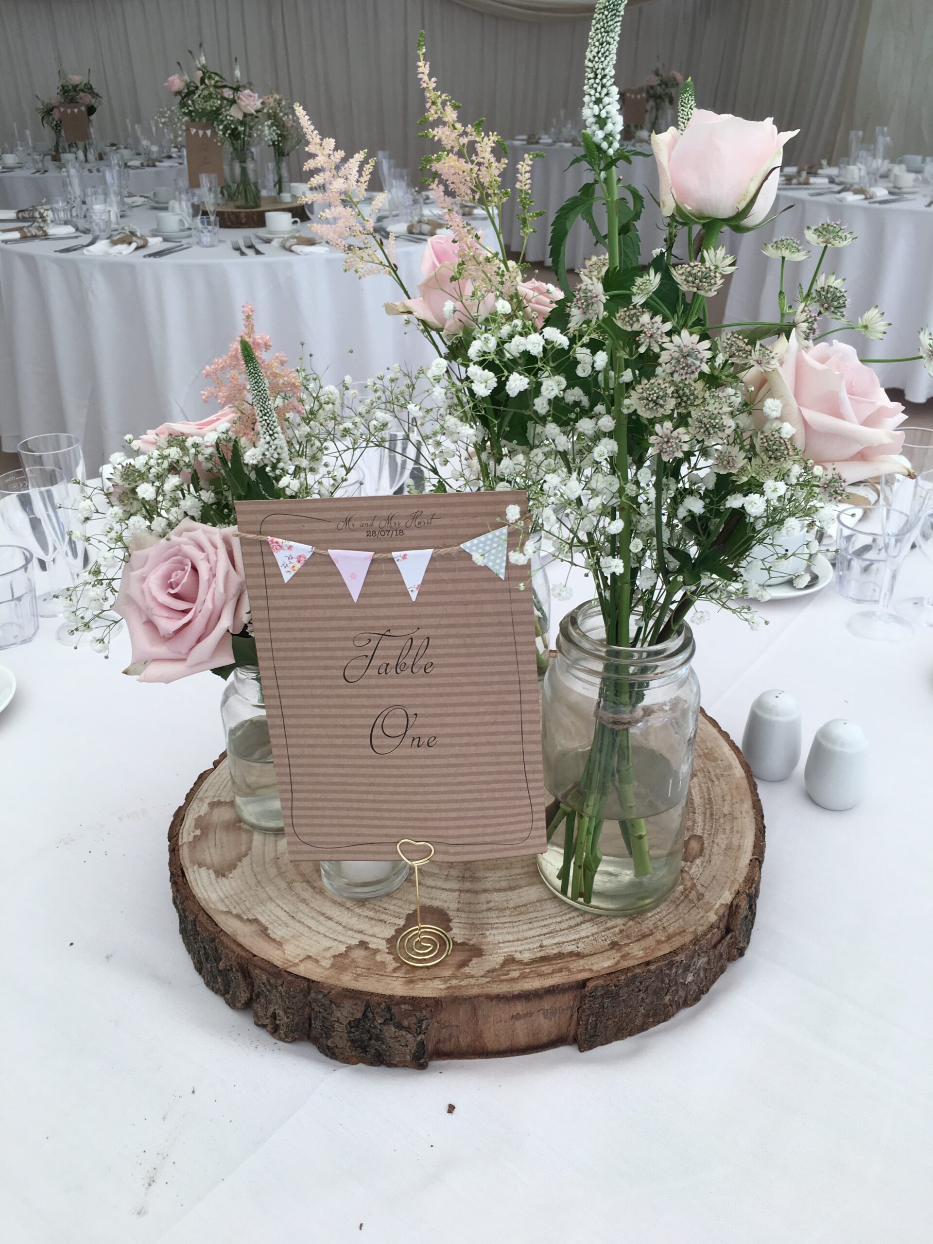 a table with flowers and a sign on it.